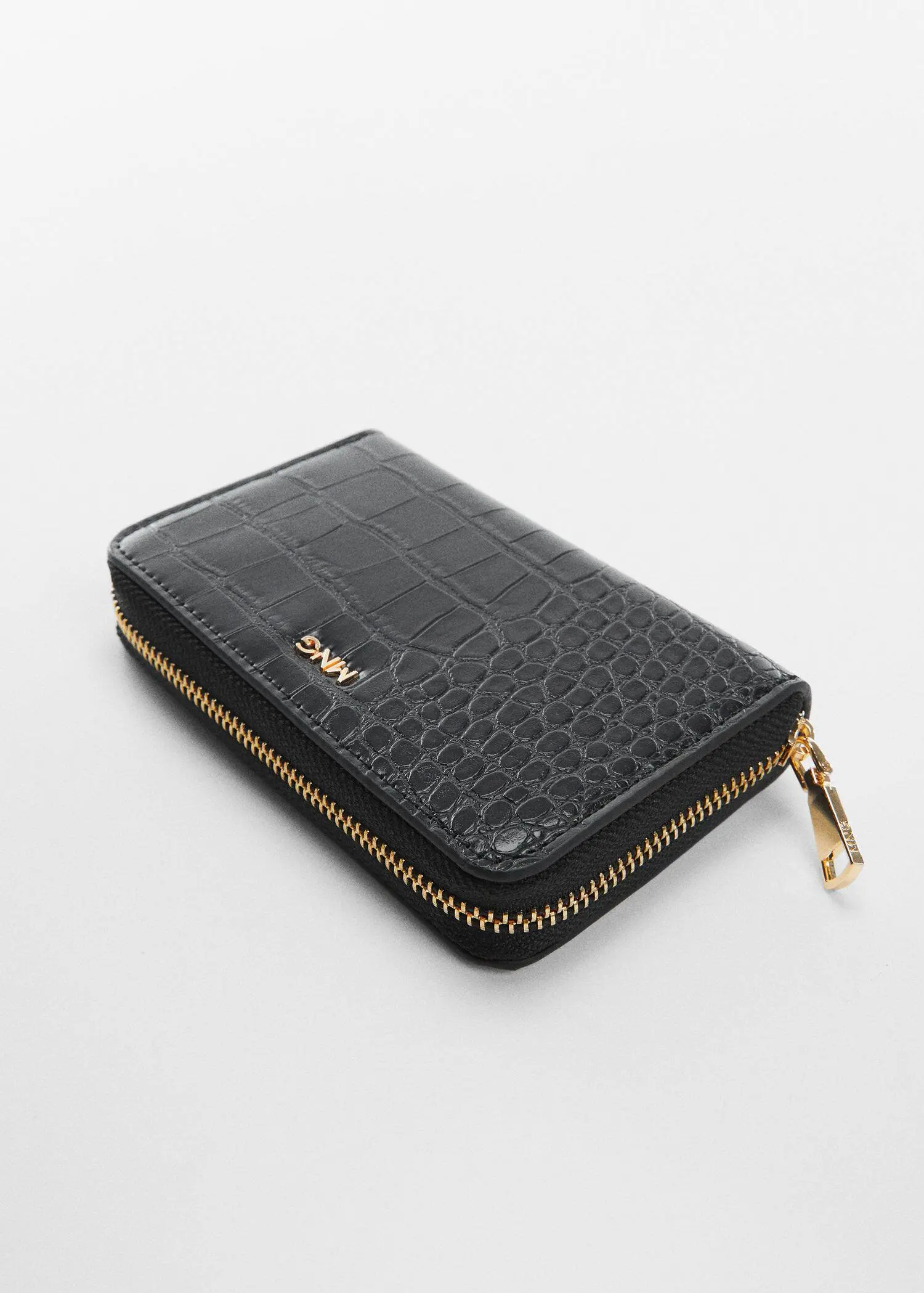 Mango Animal print effect wallet. a black wallet is sitting on a white surface. 