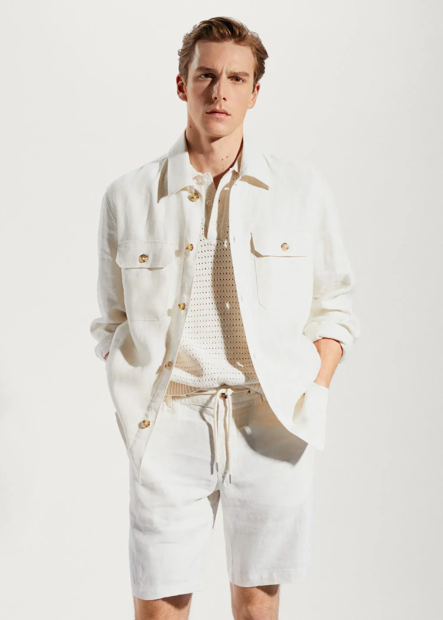 Mango 100% linen regular-fit overshirt. a man wearing a white shirt and tie. 