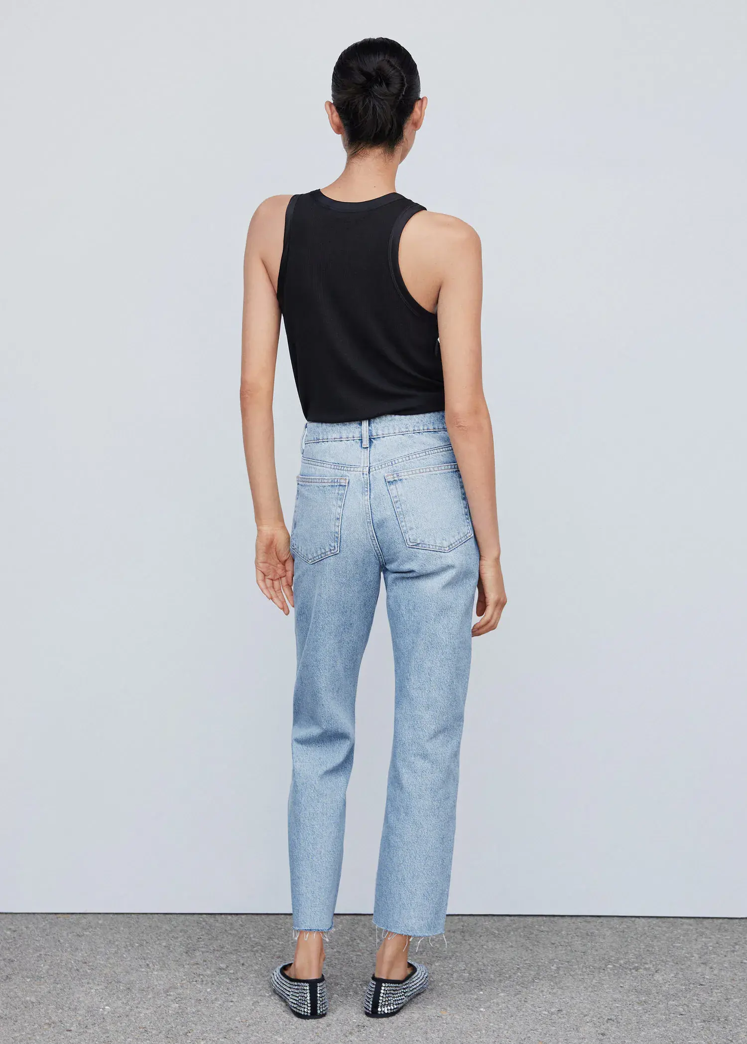 Mango High waist straight jeans. a woman wearing a black tank top and jeans. 