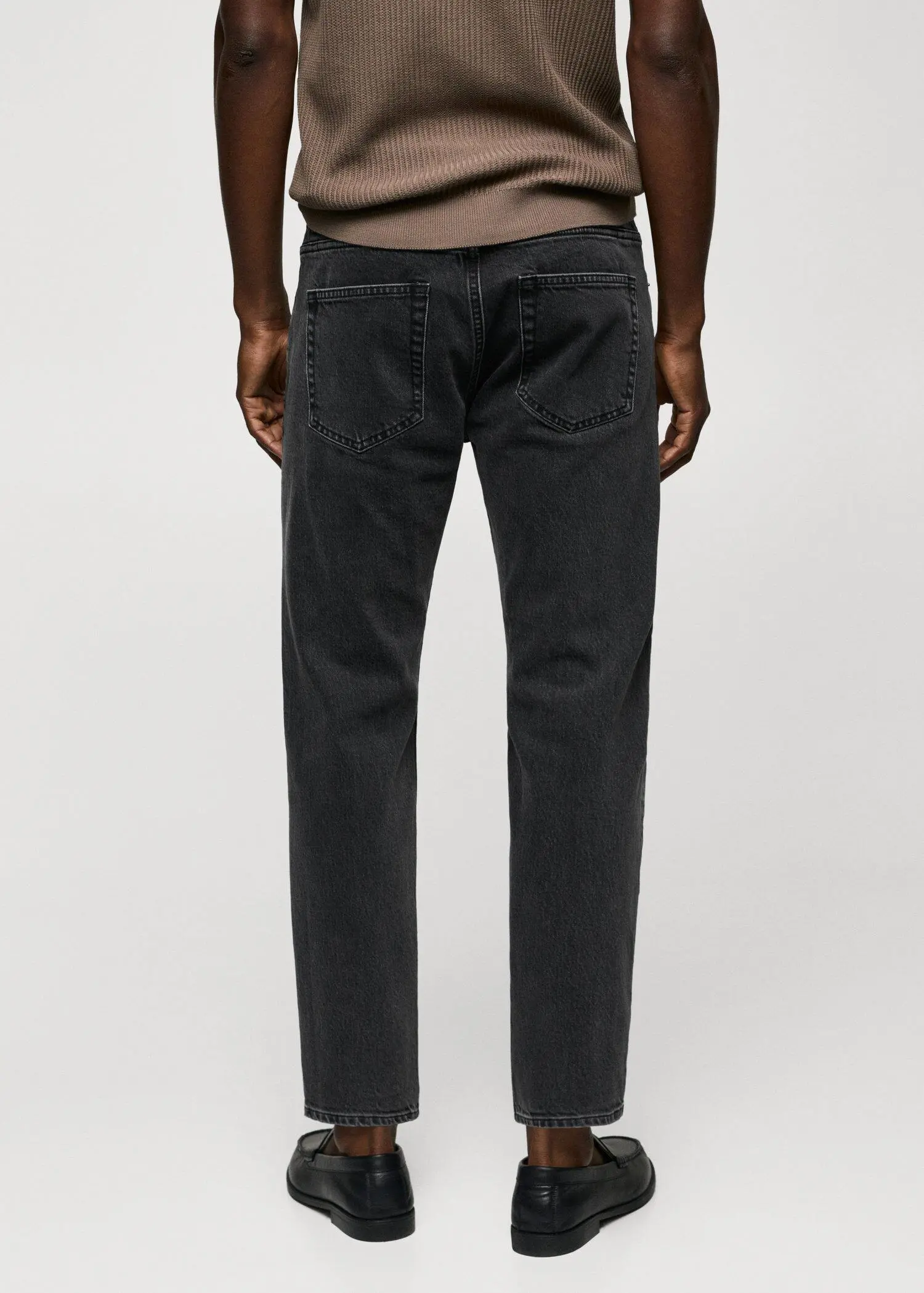 Mango Ben tapered cropped jeans. a person wearing a pair of black jeans. 