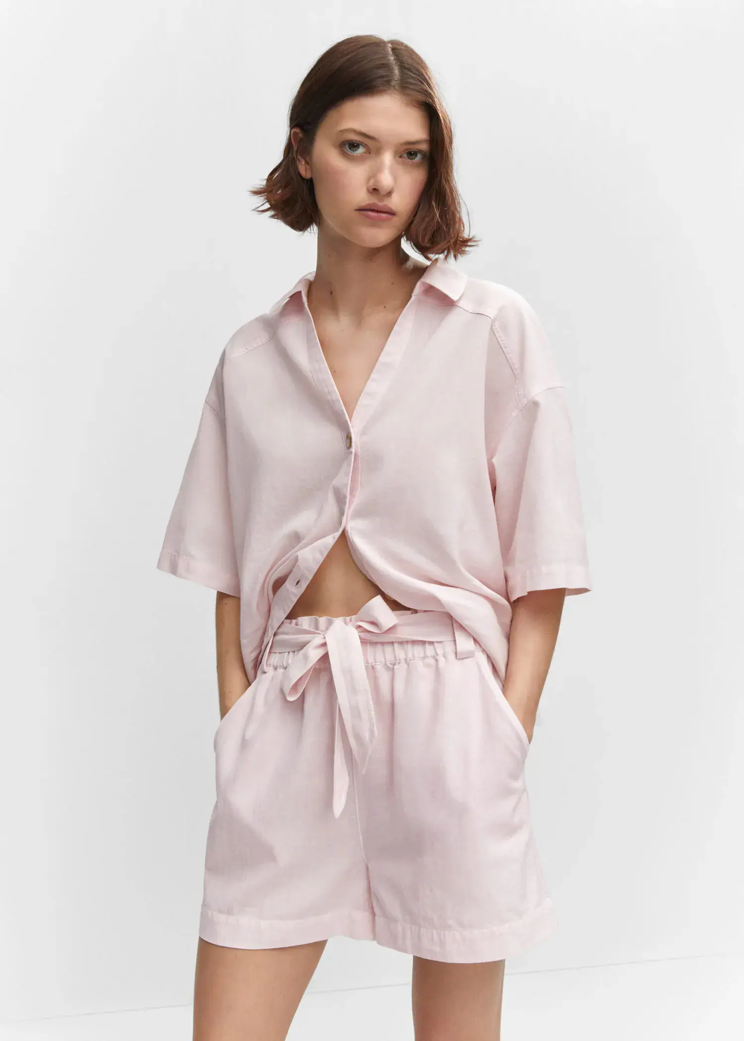 Mango Cotton linen-blend shirt. a woman wearing a pink shirt and shorts. 