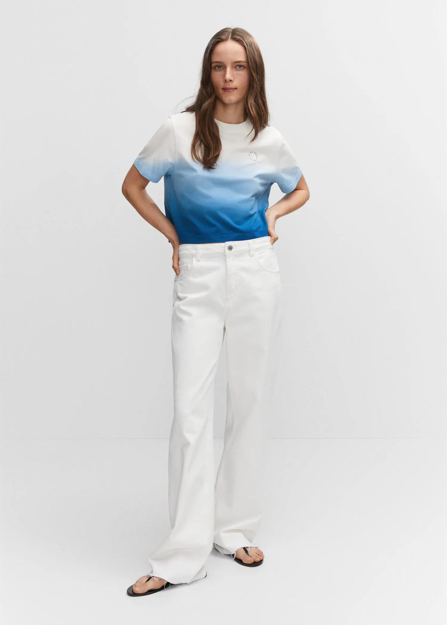 Mango Cotton ombré t-shirt. a woman in white pants and a blue top. 