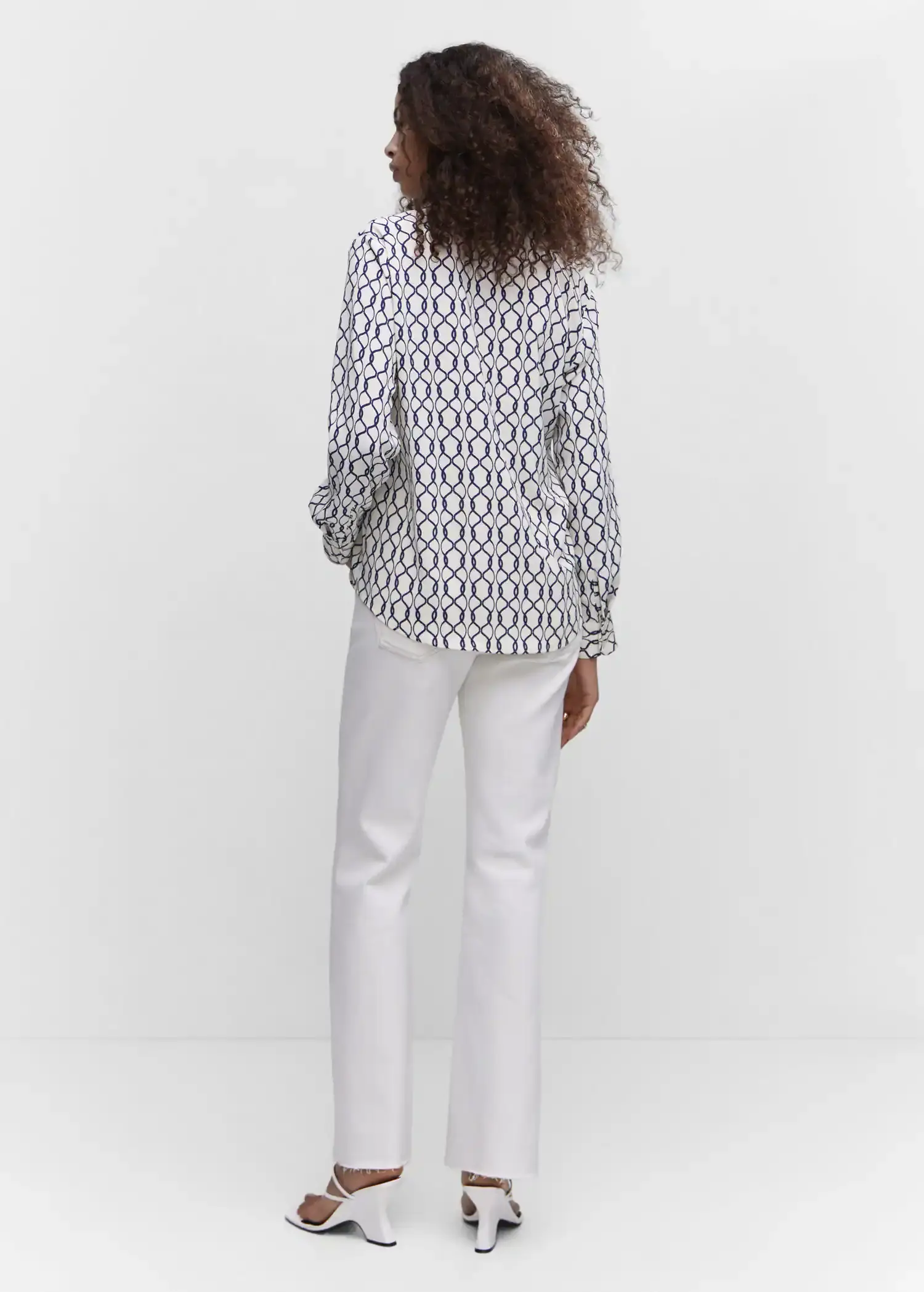 Mango Regular flowy shirt. a woman wearing white pants and a white shirt. 