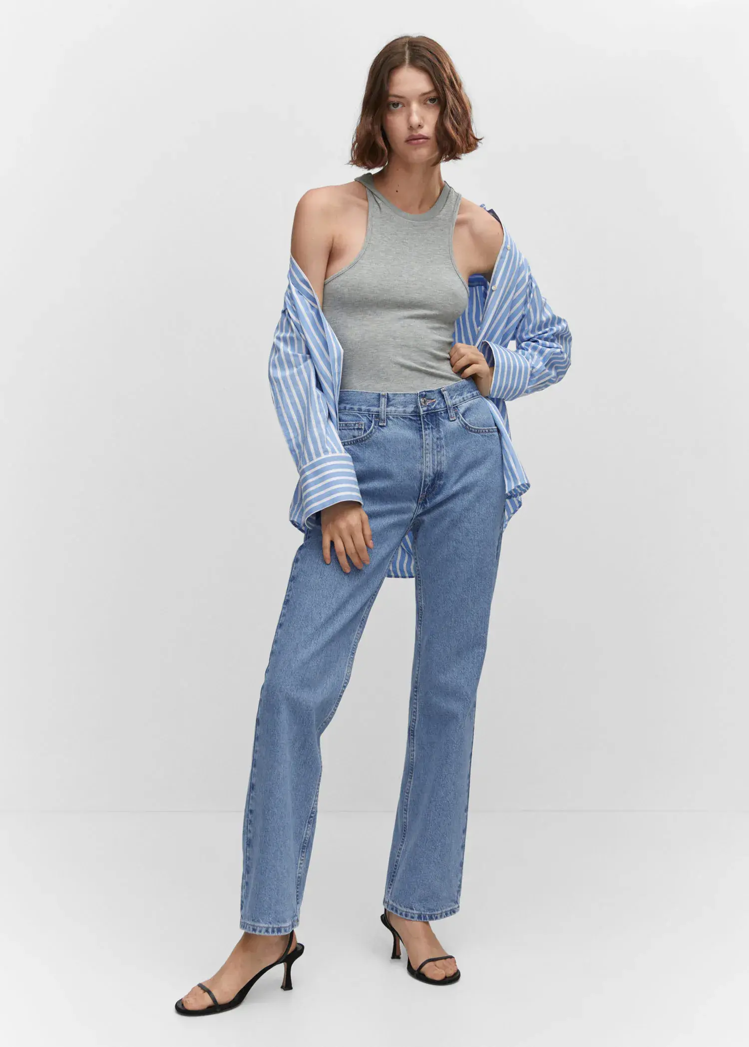Mango Mid-rise straight jeans. a woman wearing a blue shirt and jeans. 