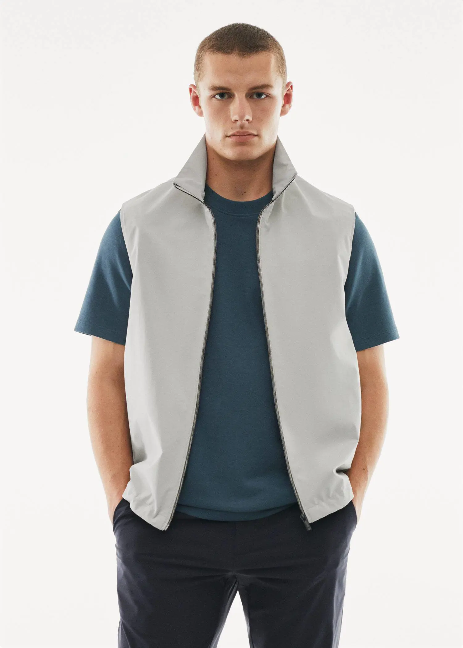Mango Water-repellent technical gilet. a young man wearing a white vest and a blue shirt. 