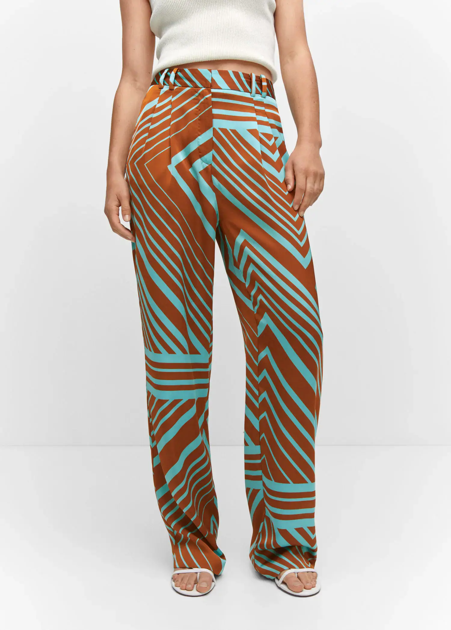 Mango Satin printed pants. a person wearing a pair of brown and blue pants. 