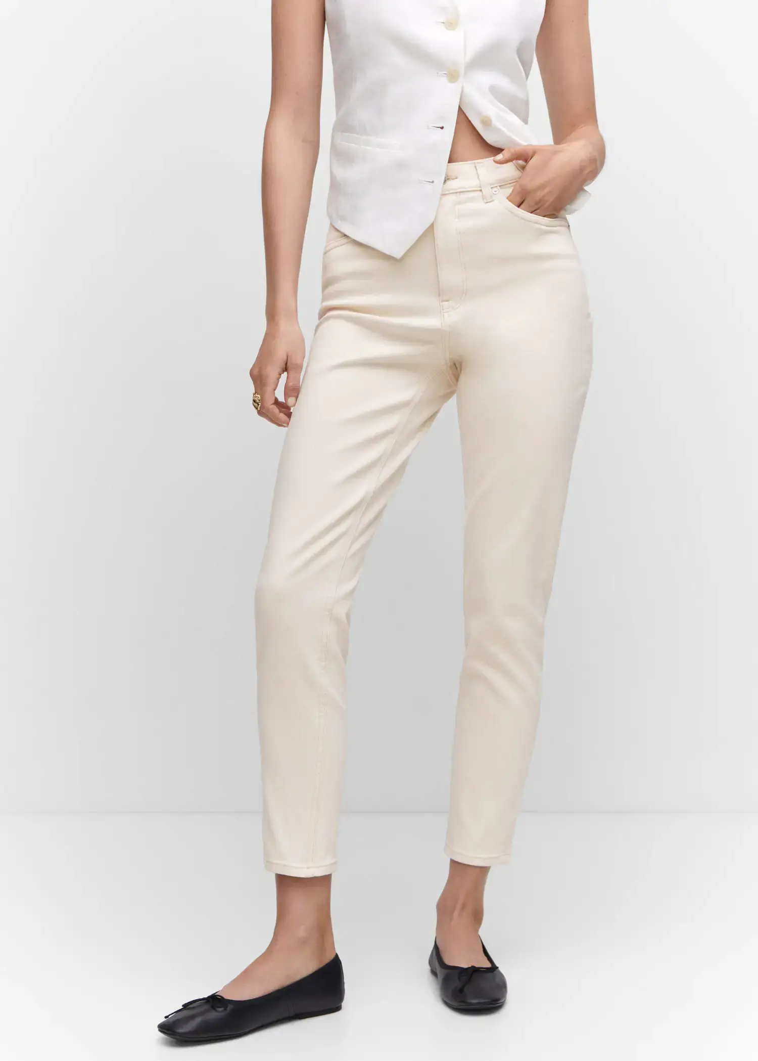 Mango Mom comfort high-rise jeans. a woman in white pants and a white shirt. 