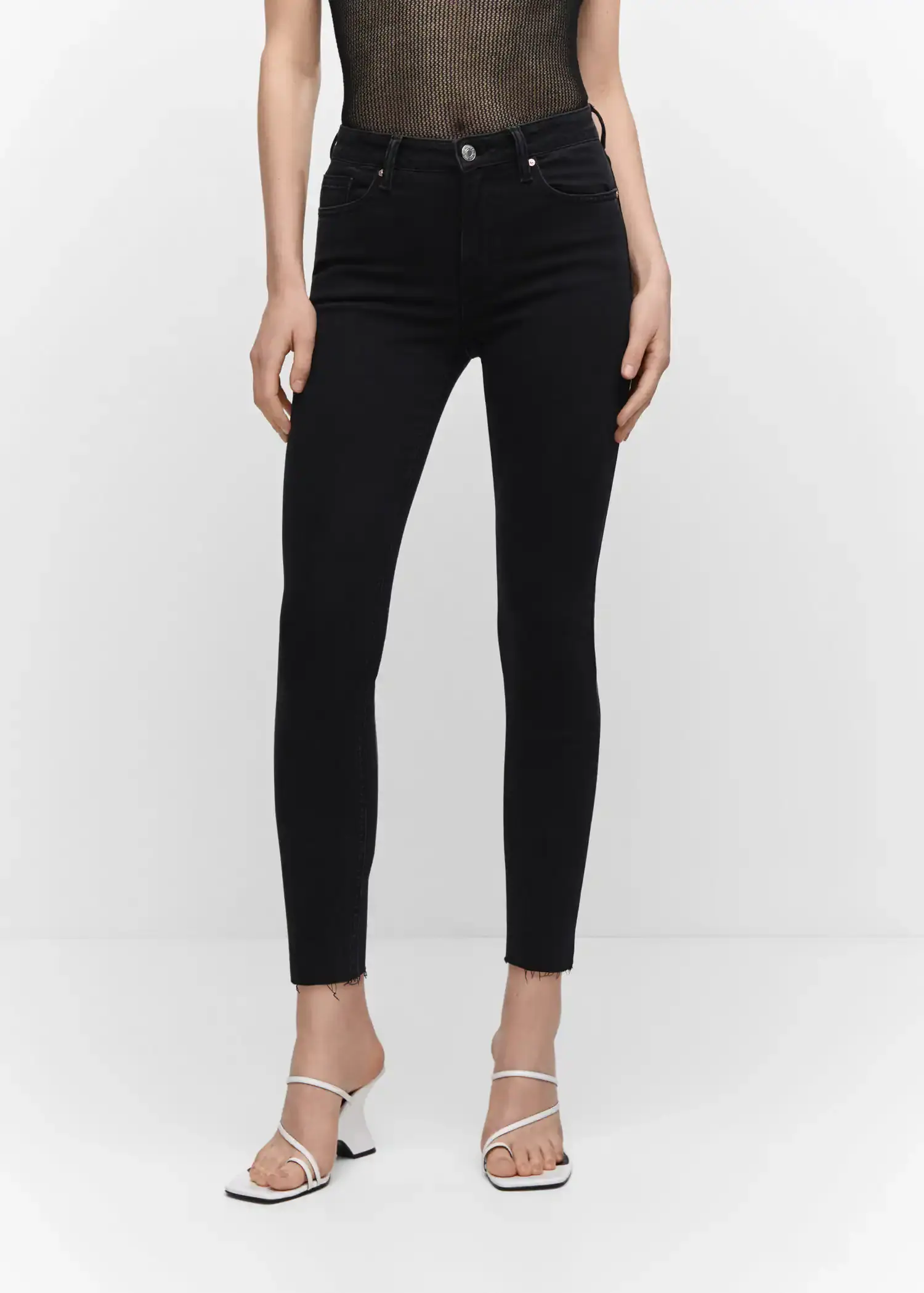 Mango Skinny cropped jeans. a pair of black pants are on a woman. 