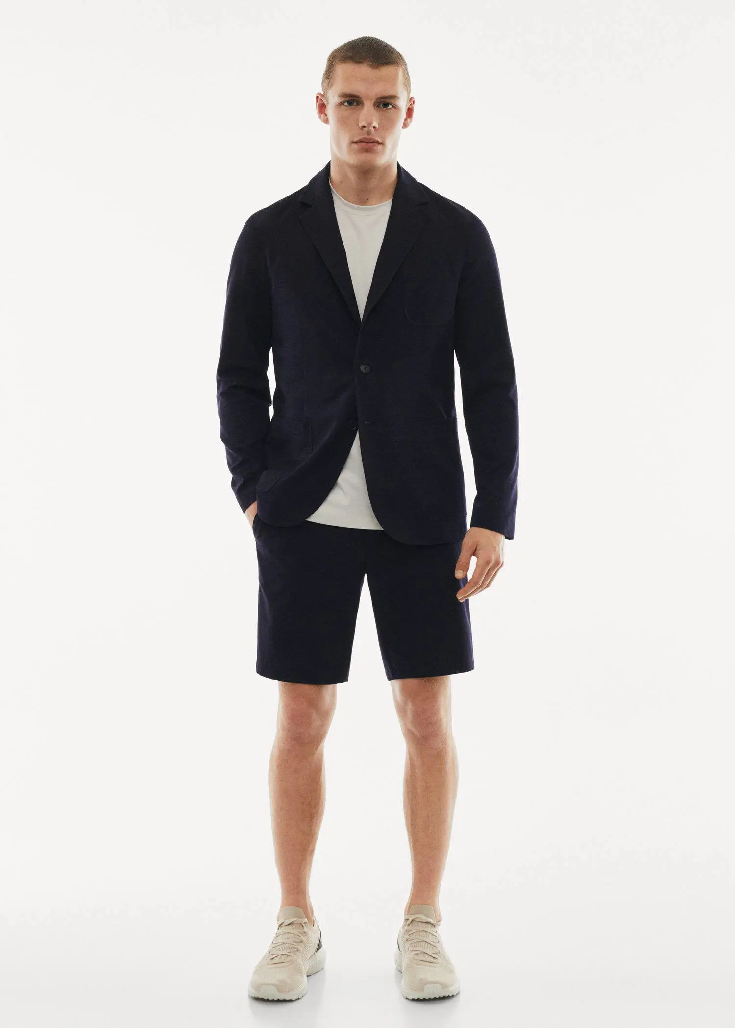 Mango Water-repellent stretch shorts. a man in a black jacket and white shirt. 