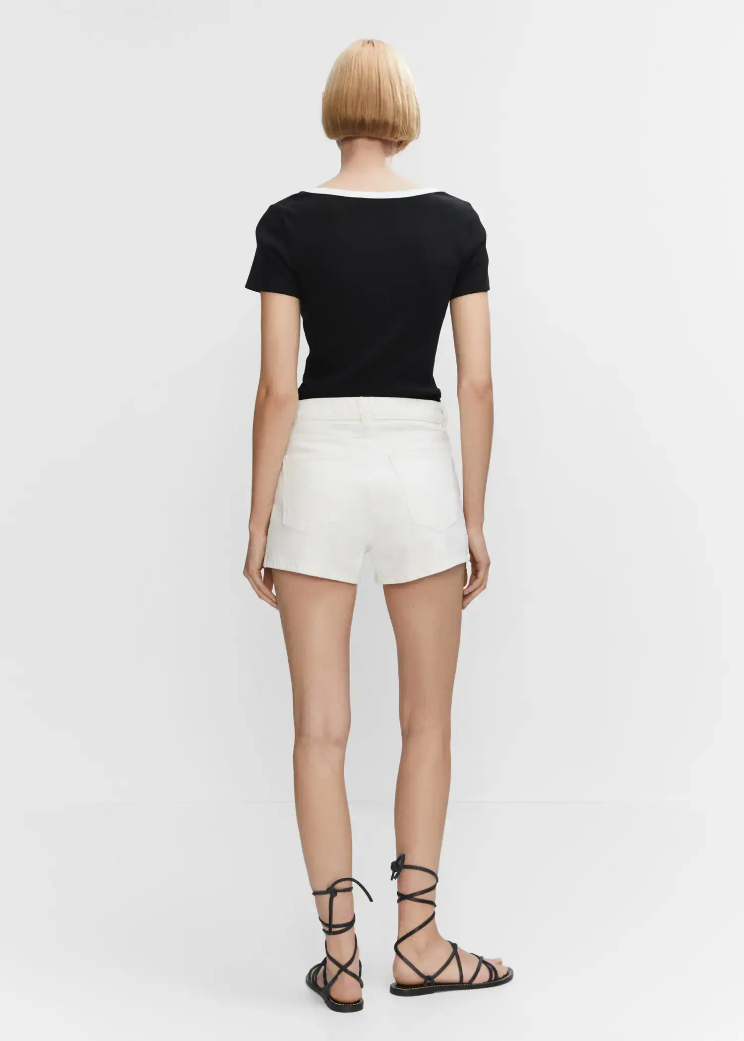Mango Contrast collar shirt. a woman wearing white shorts and a black top. 