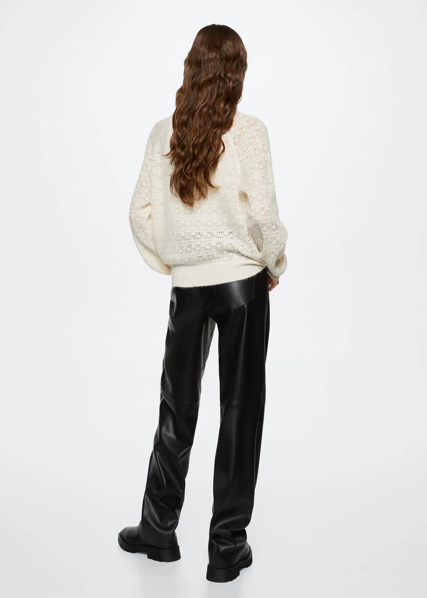 Mango Openwork knit sweater. a woman in a white sweater and black pants. 