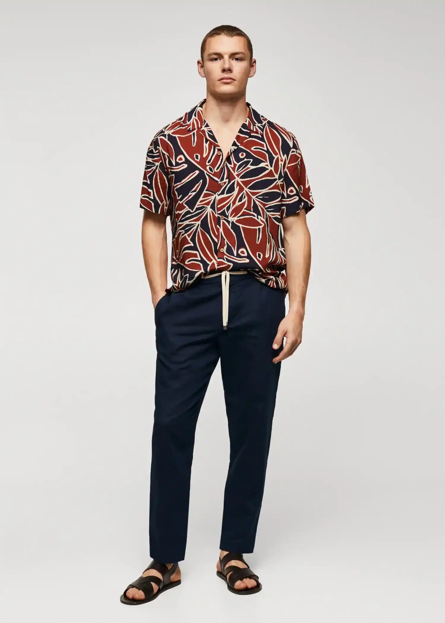 Mango Bowling shirt with leaf print. a man wearing a red and black shirt and black pants. 