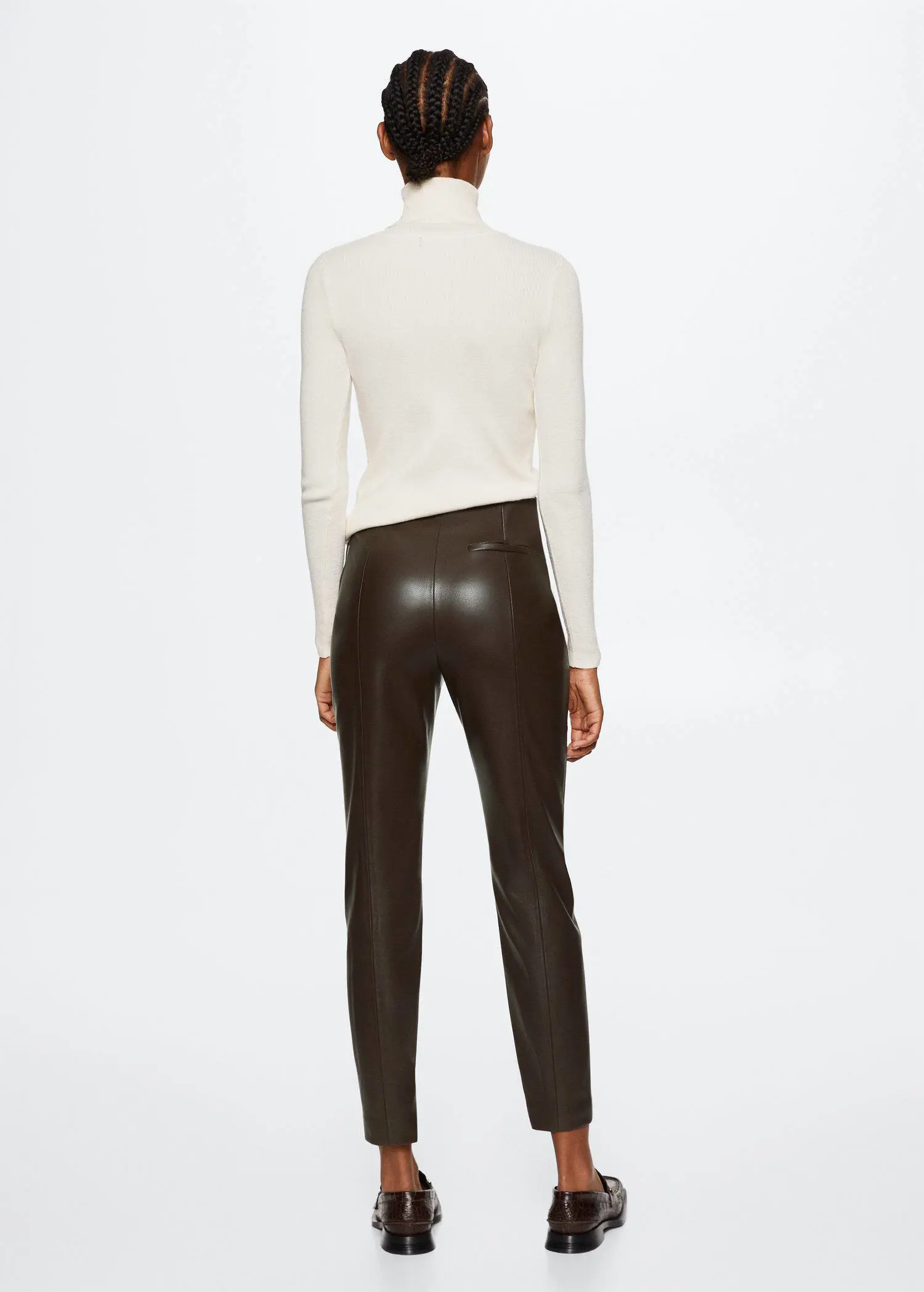 Mango Leather-effect leggings with split hems. a woman wearing a white shirt and brown pants. 