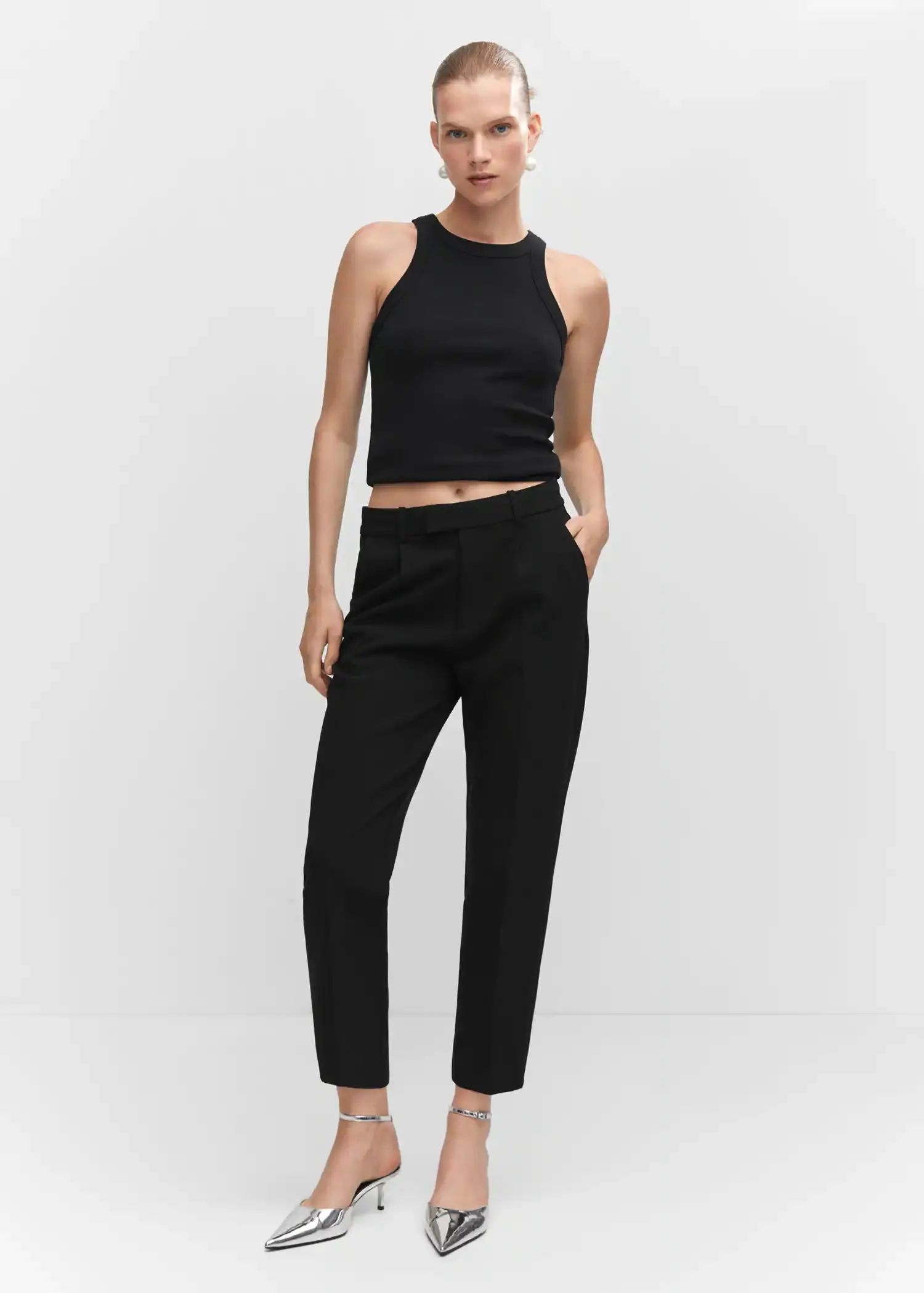 Mango Ribbed cotton-blend top. a woman wearing a black top and black pants. 