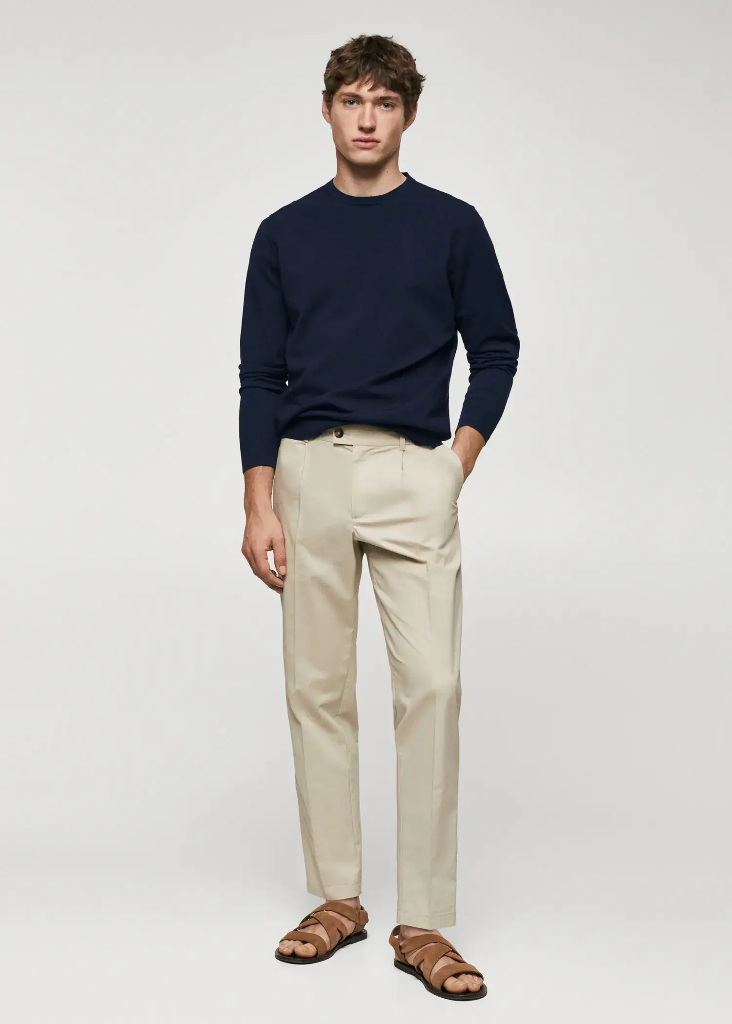 Mango Fine-knit sweater. a man in a navy blue sweater and beige pants. 