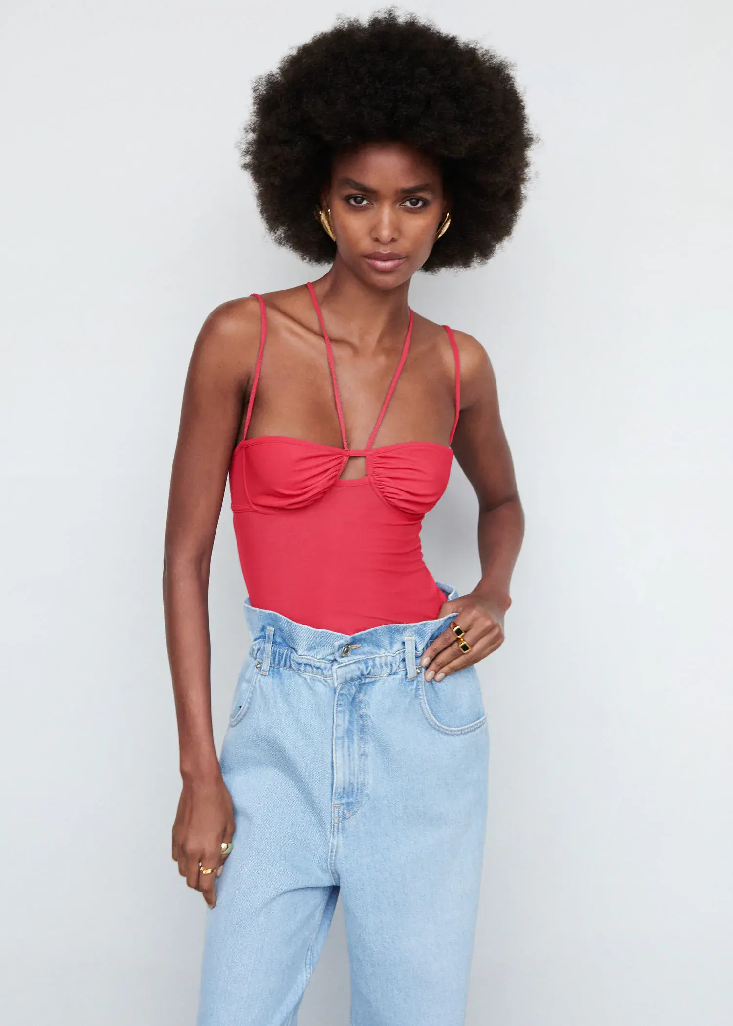 Mango Double straps top. a woman in a red top and blue jeans. 