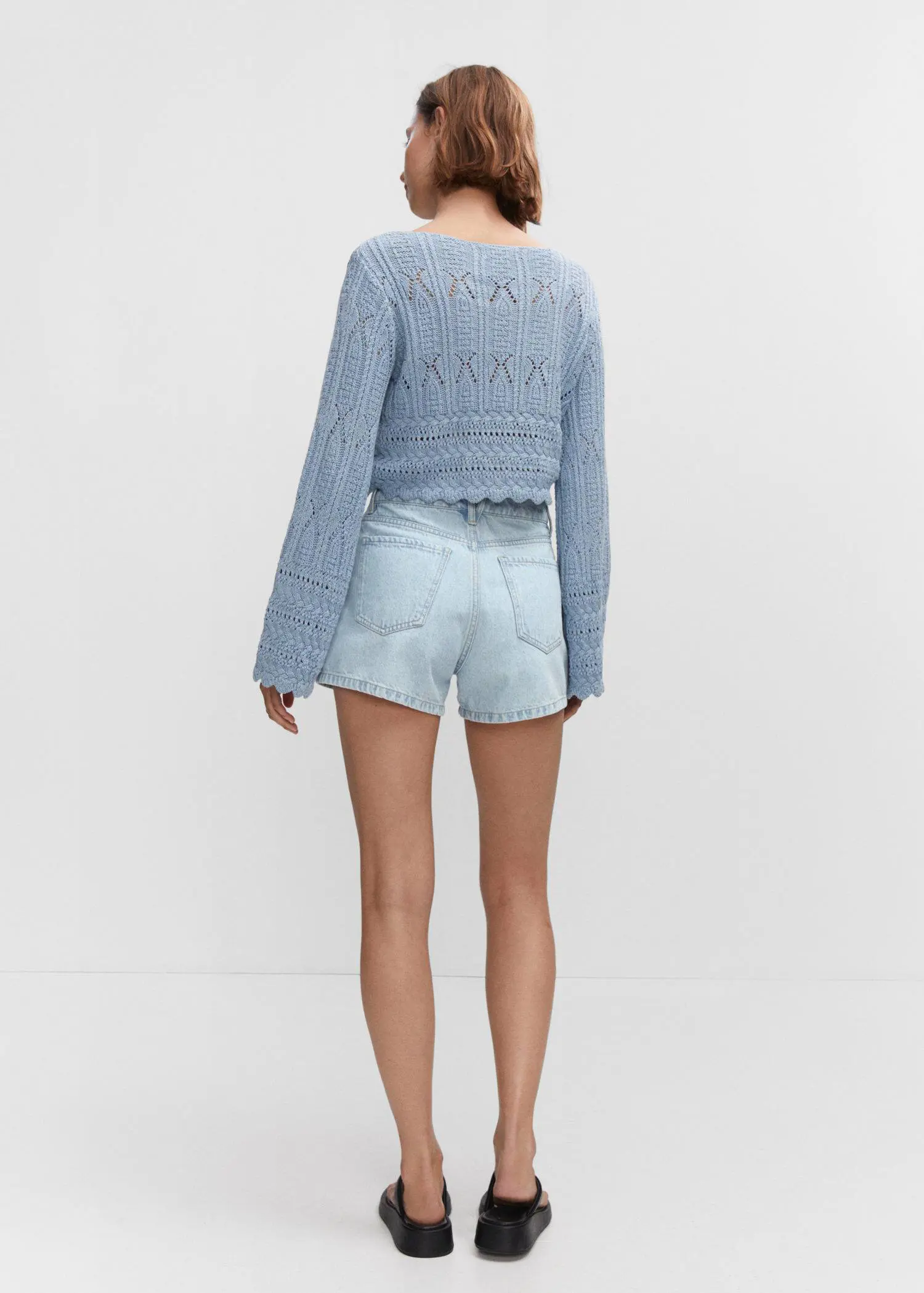 Mango Denim shorts with buttons. a woman wearing a light blue sweater and shorts. 