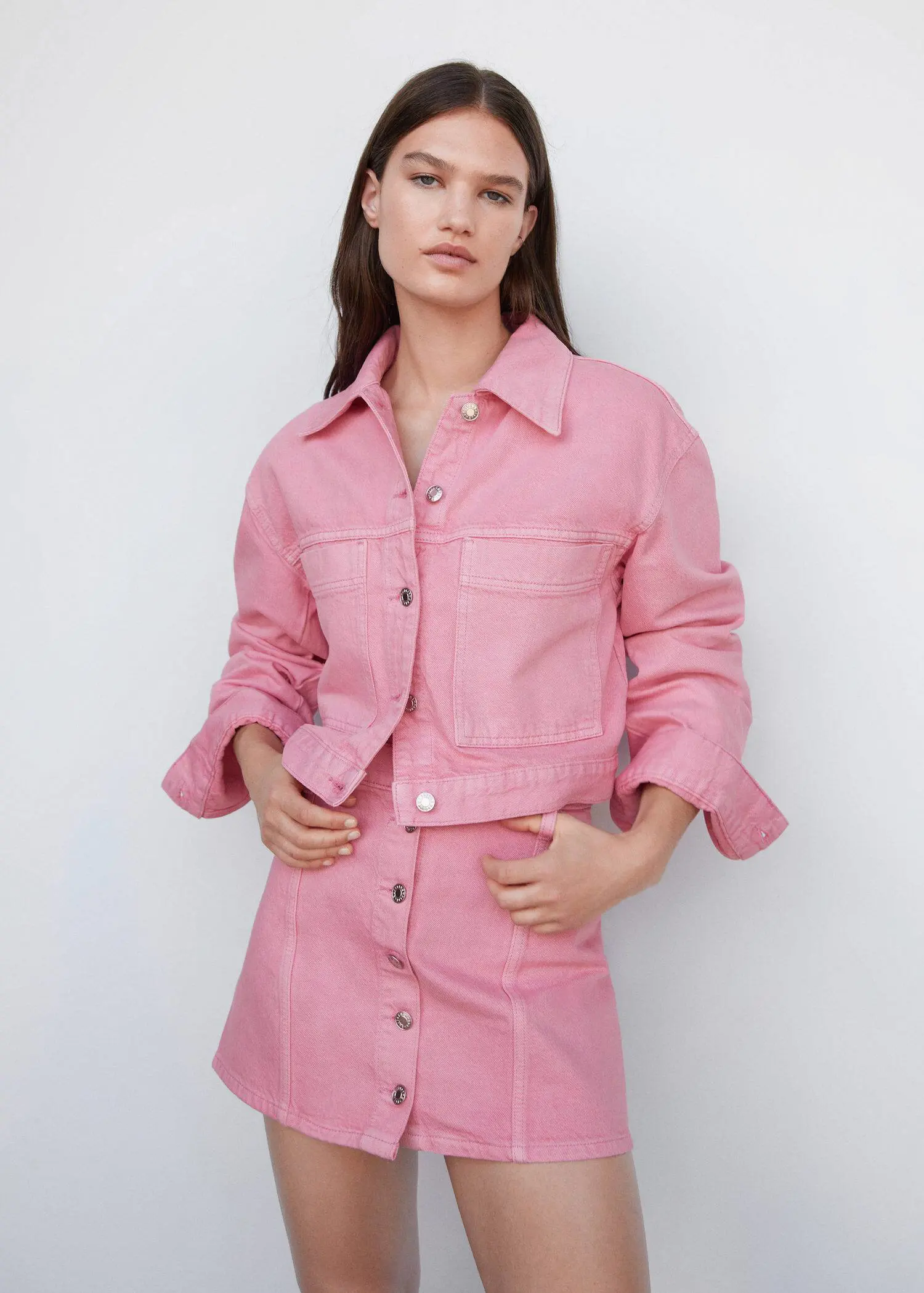 Mango Pocketed denim jacket. a woman wearing a pink jacket and skirt. 