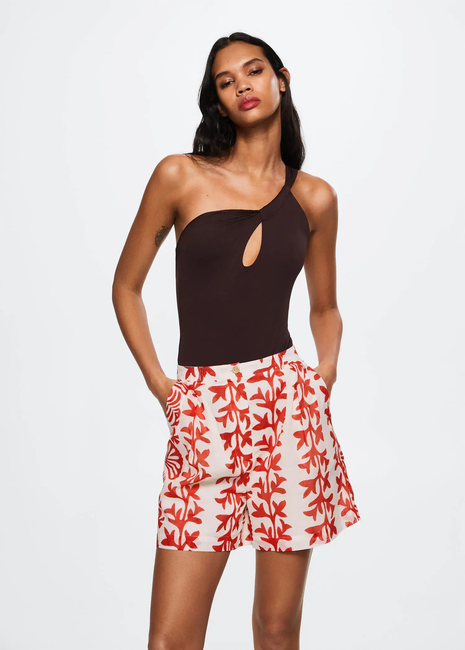 Mango Printed cotton-blend short. a woman in a brown top and a red and white leaf print shorts. 
