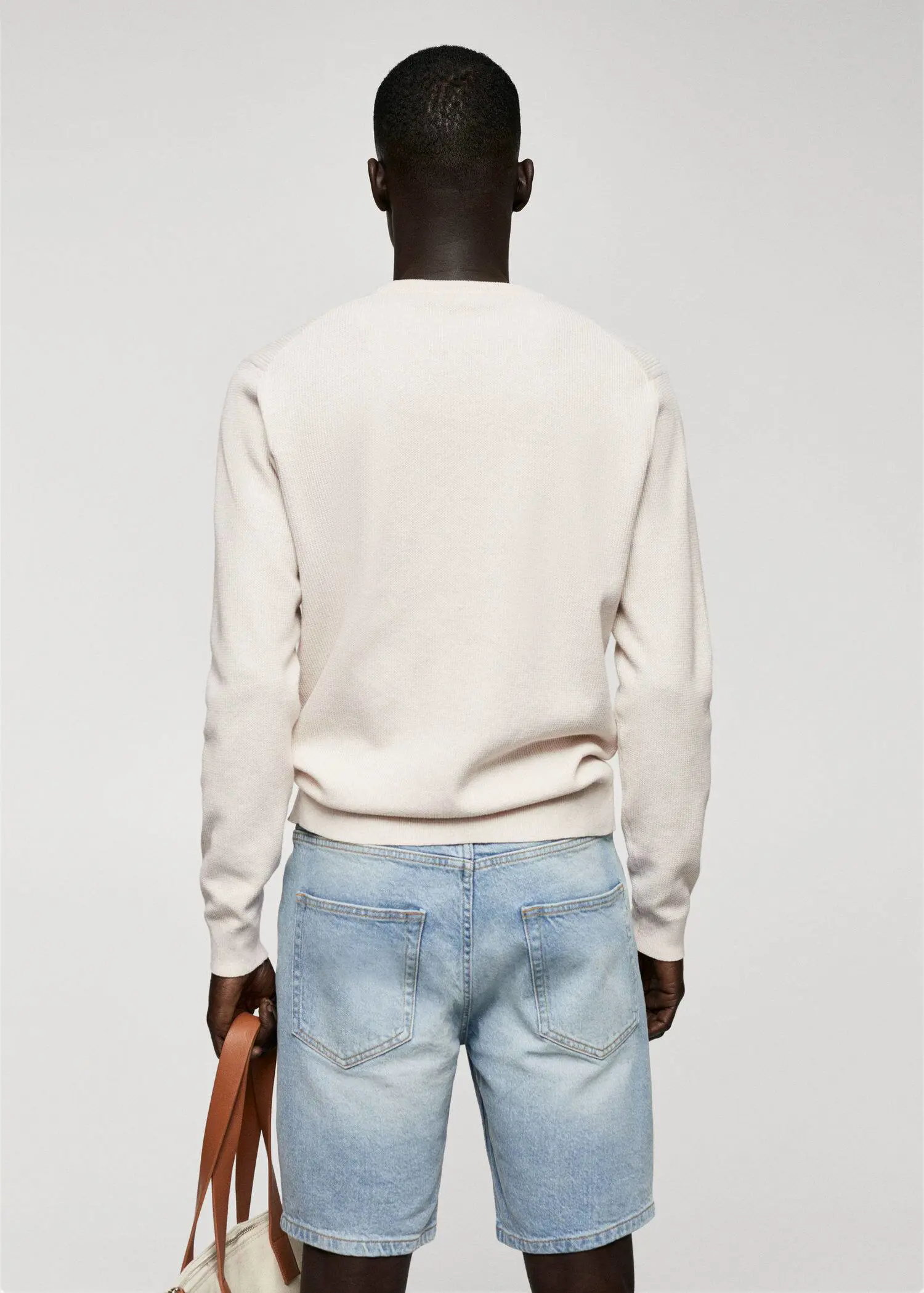 Mango Structured cotton sweater. a man wearing a white sweater and jeans. 