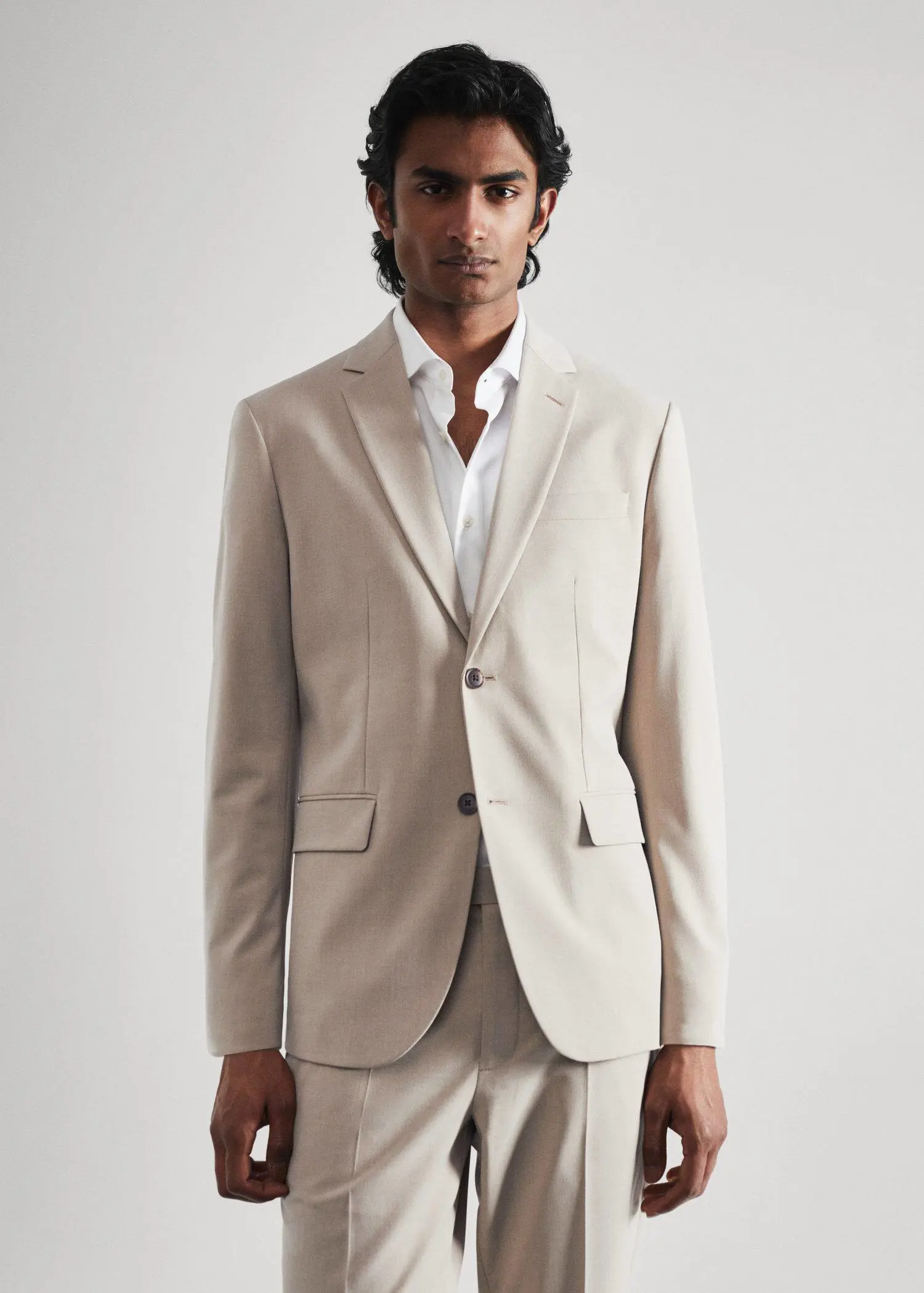 Mango Stretch fabric slim-fit suit blazer. a man wearing a suit and a white shirt. 