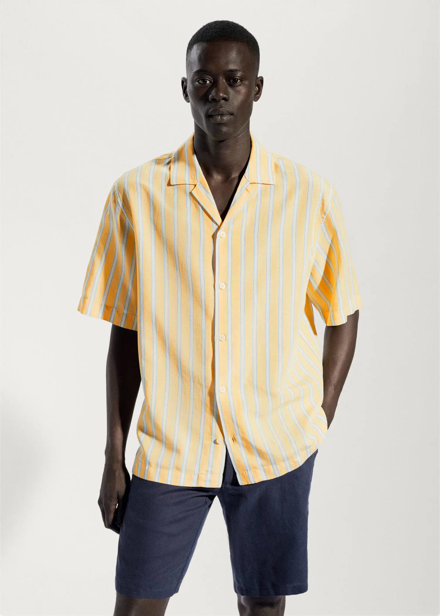 Mango Striped cotton linen shirt. a man wearing a yellow and white striped shirt. 