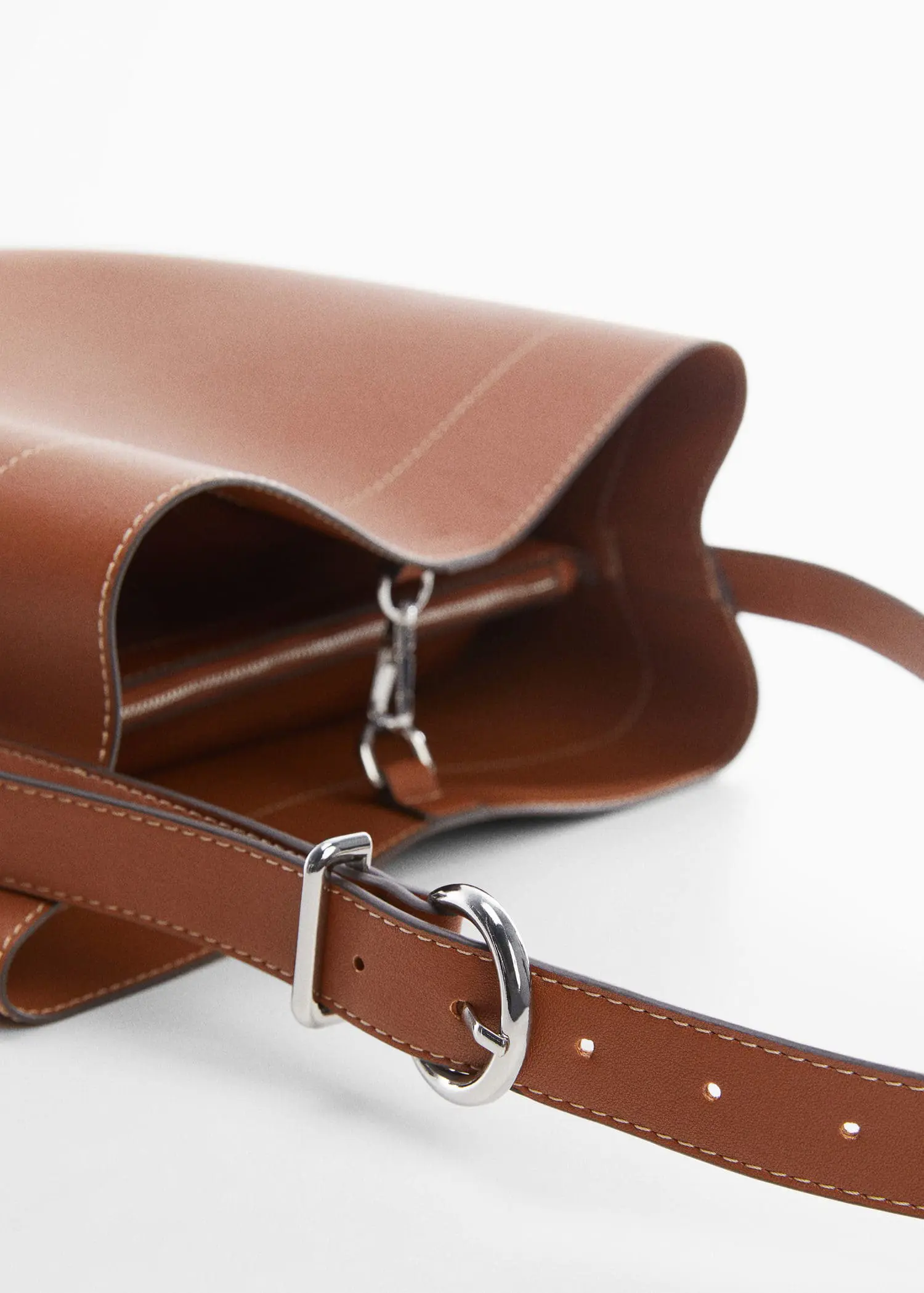 Mango Short handle shopper bag. a close-up of a brown leather purse. 