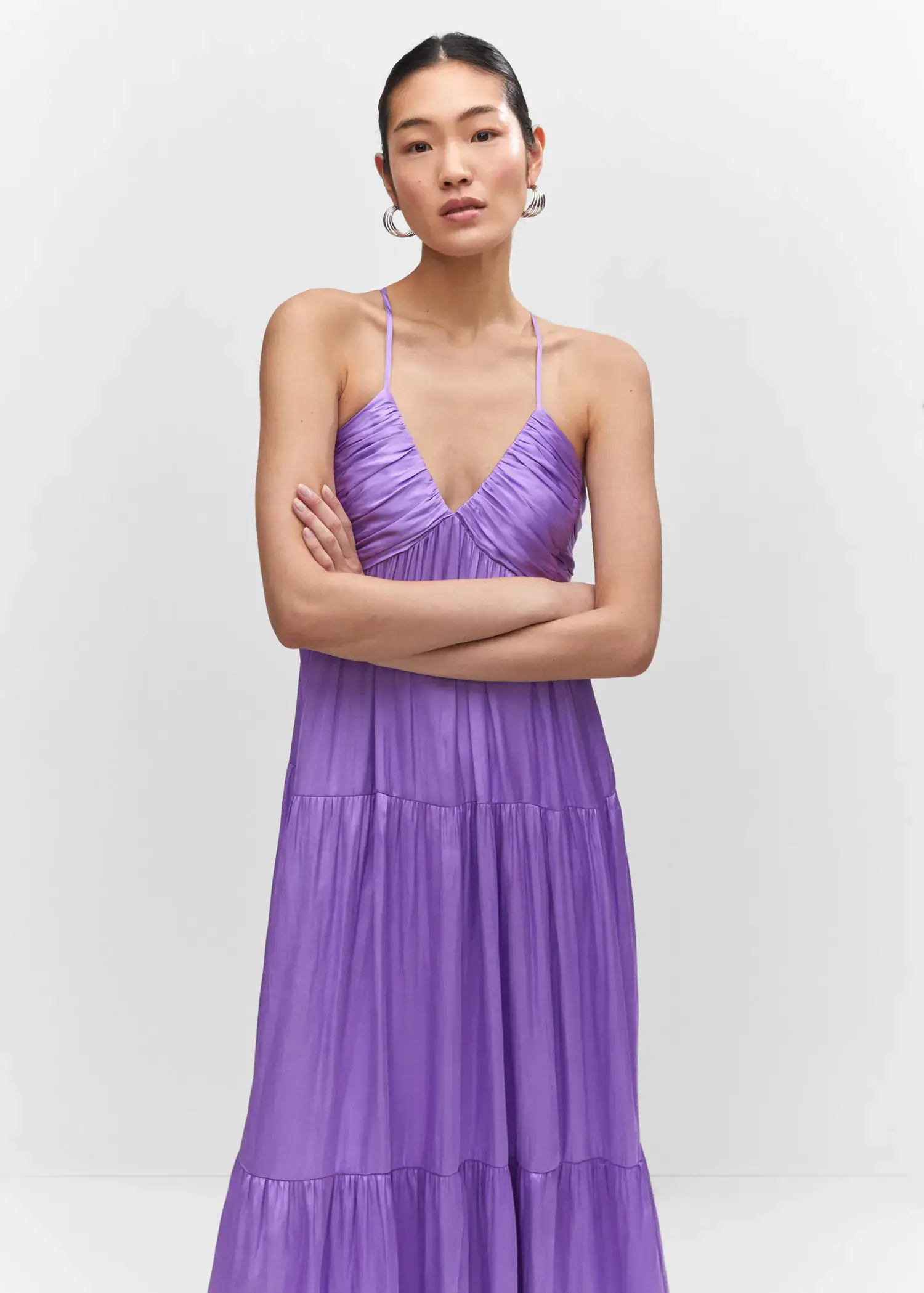 Mango Ruched satin dress. a woman wearing a purple dress standing with her arms crossed. 