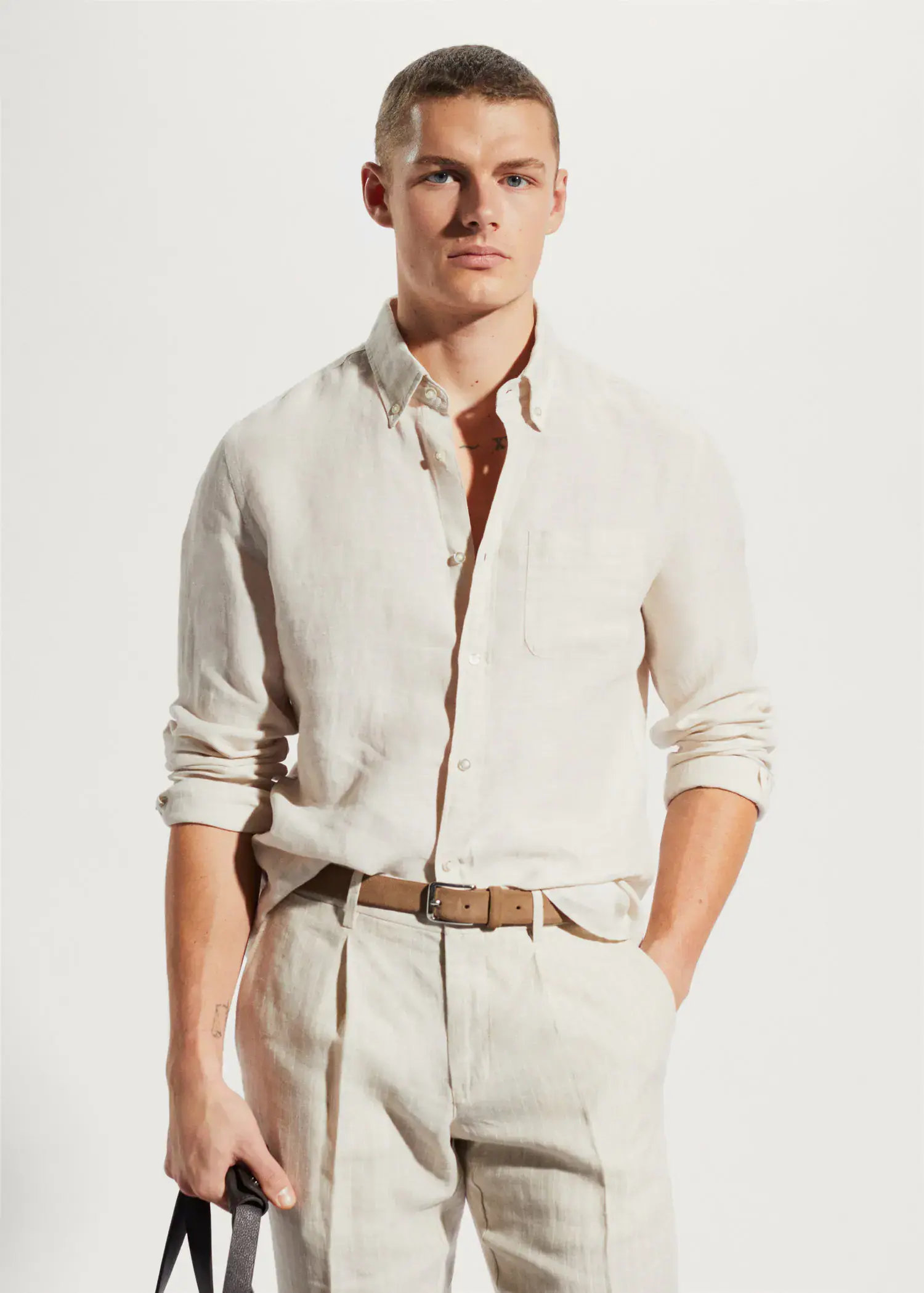 Mango 100% linen slim-fit shirt. a man wearing a white shirt and a tan belt. 