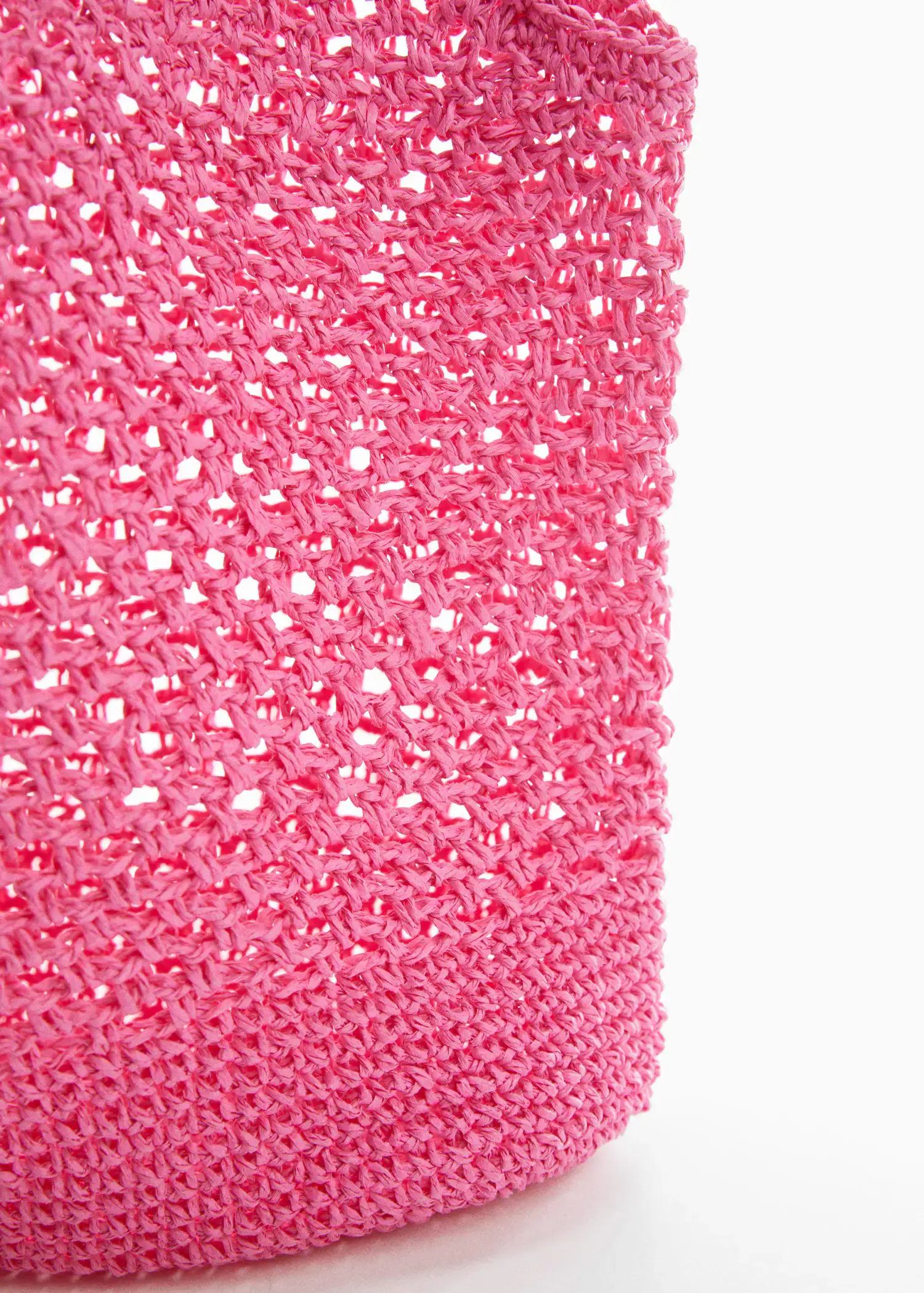 Mango Natural fibre sack bag. a close-up view of a pink crocheted bag. 