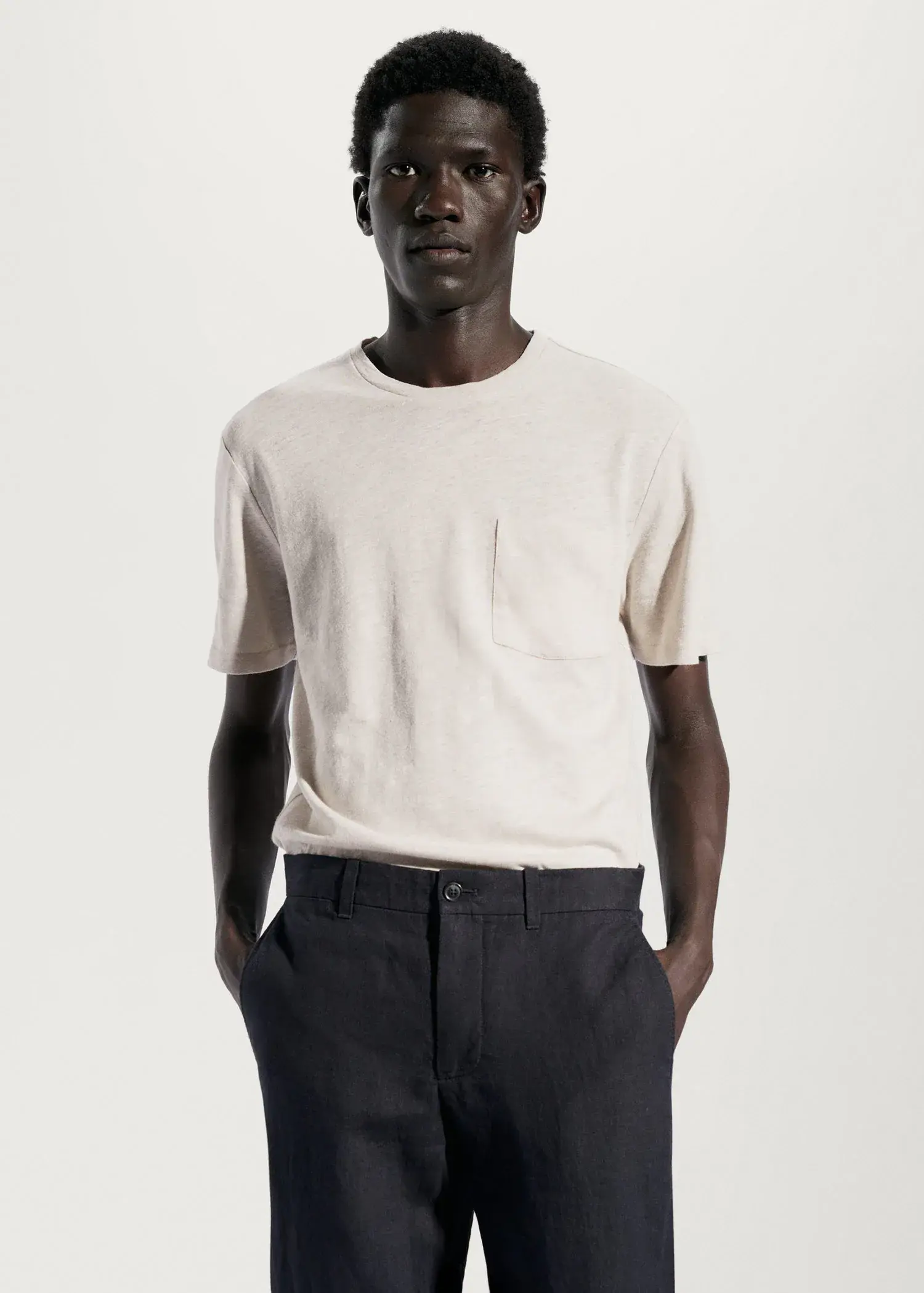 Mango Cotton-linen pocket t-shirt. a man wearing a white shirt and black pants. 