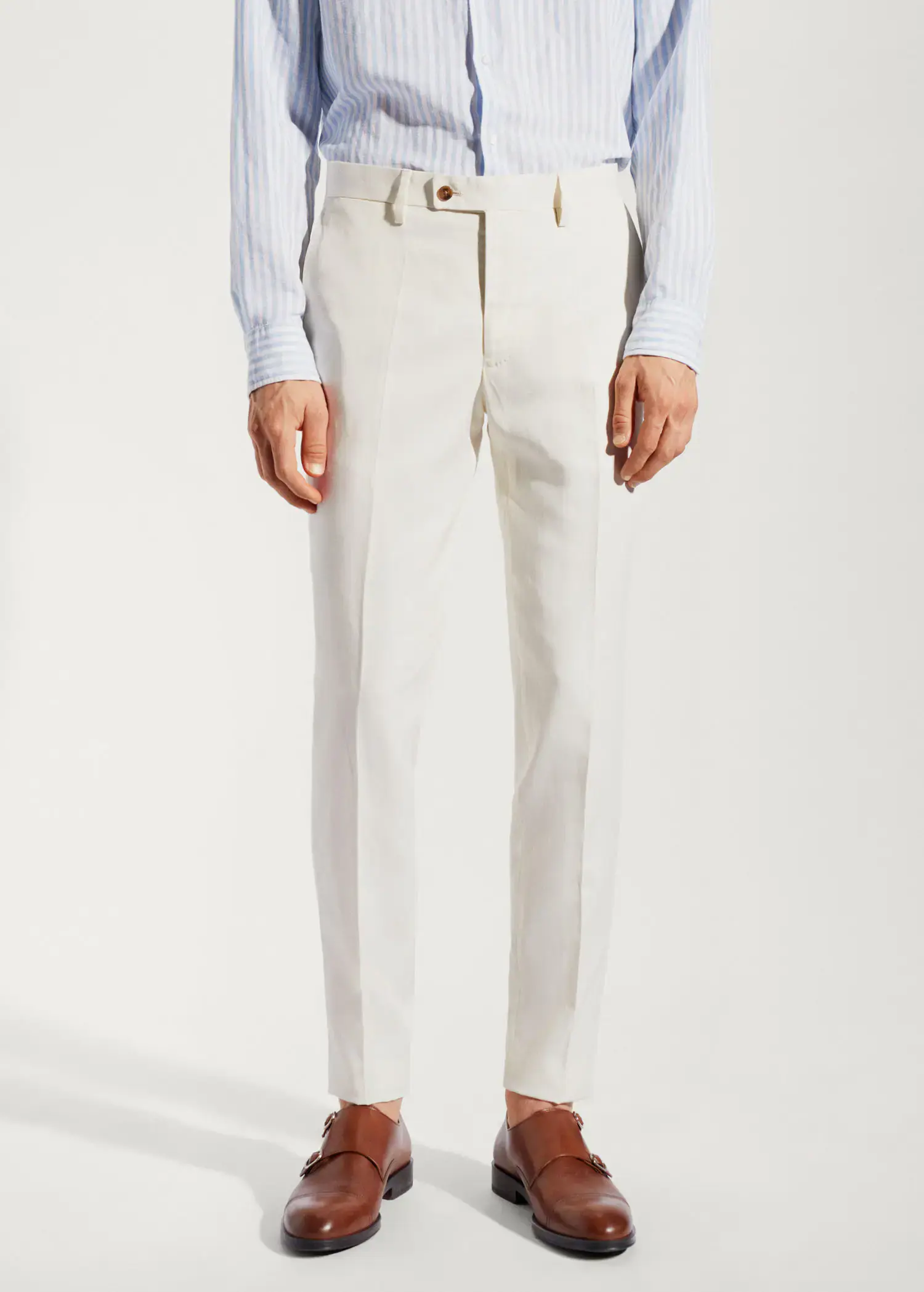 Mango 100% linen suit trousers. a man wearing a pair of white dress pants. 