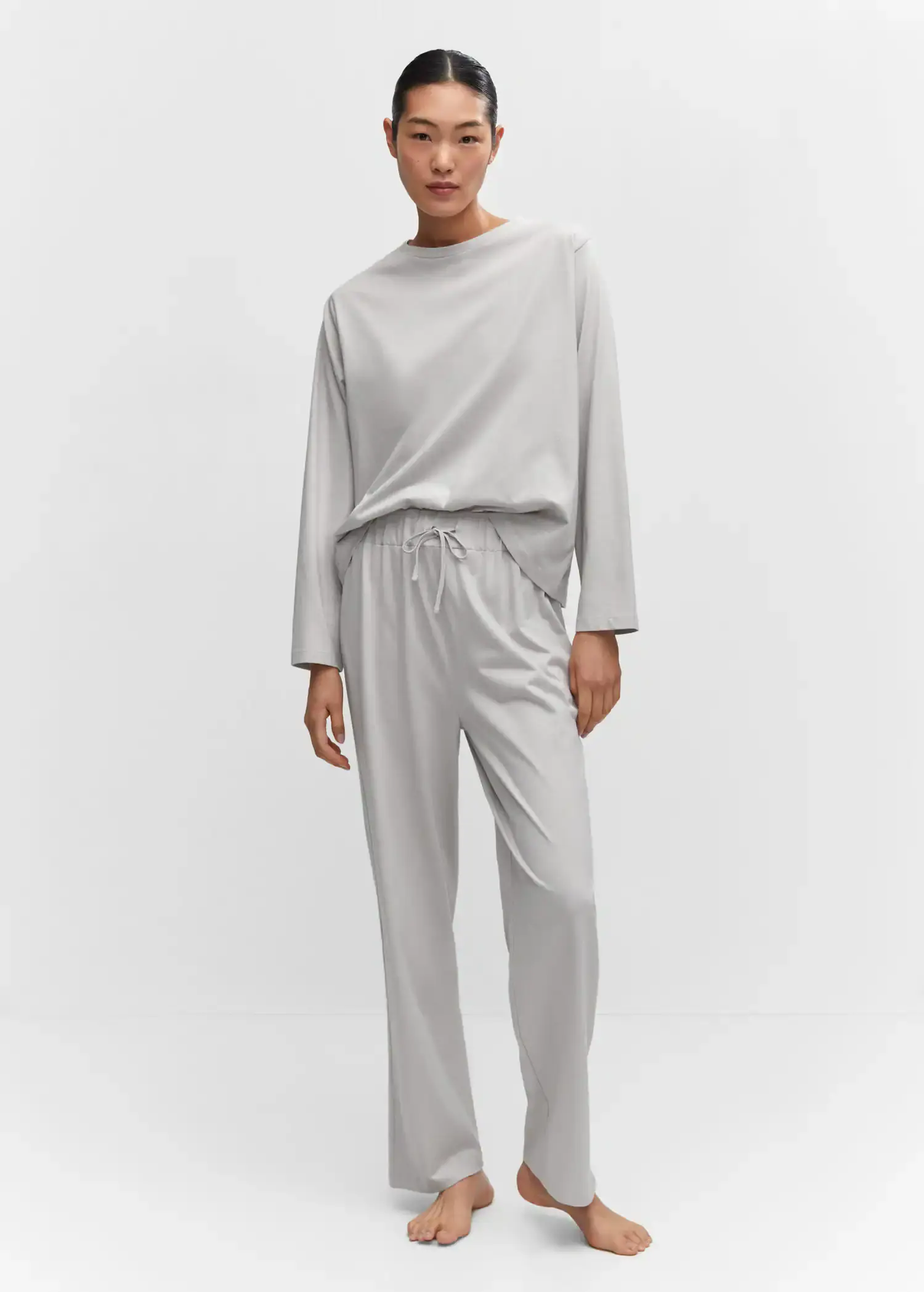 Mango Cotton long pyjamas. a person standing in a room wearing a gray outfit. 