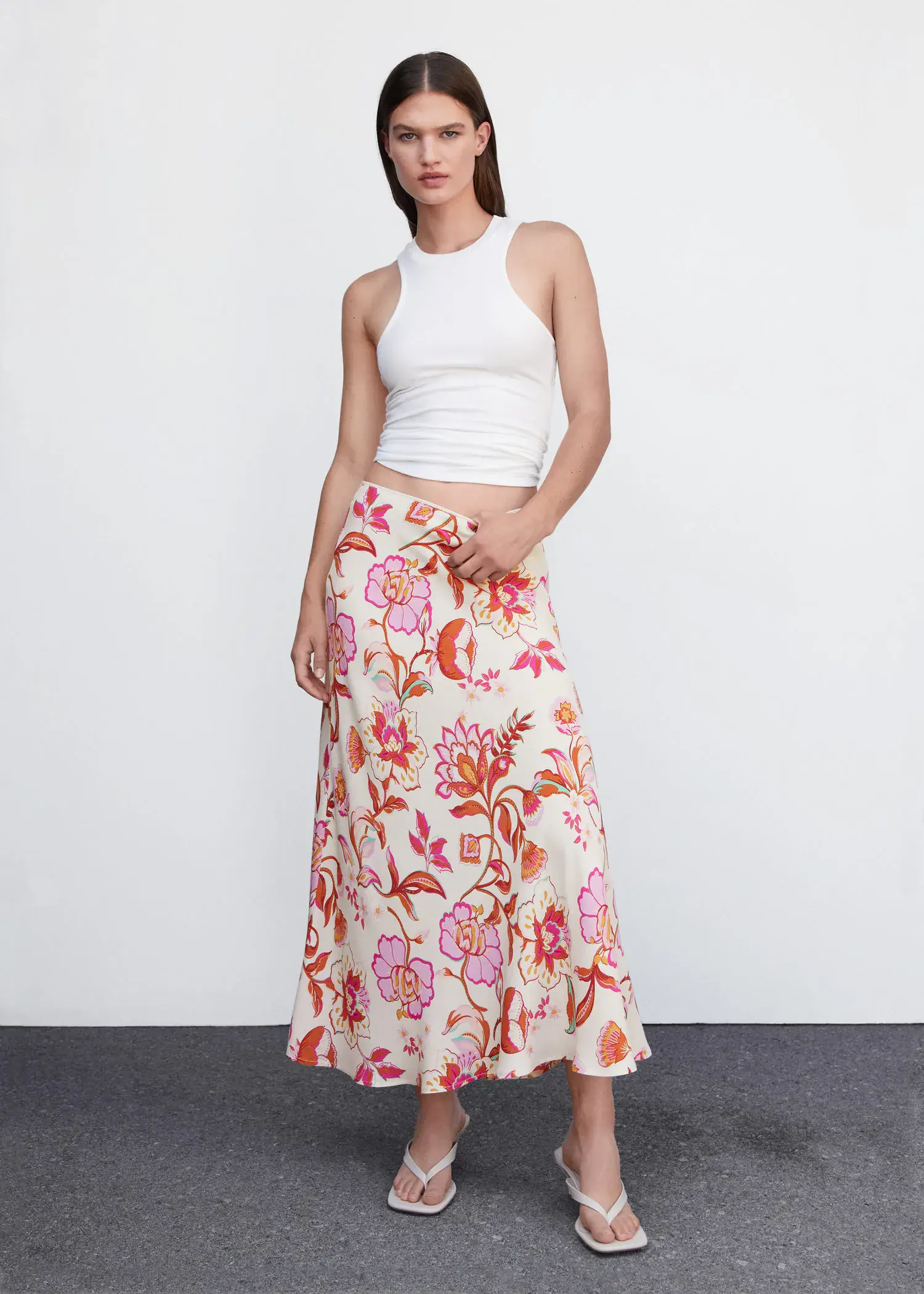 Mango Floral long skirt. a woman standing in front of a white wall. 