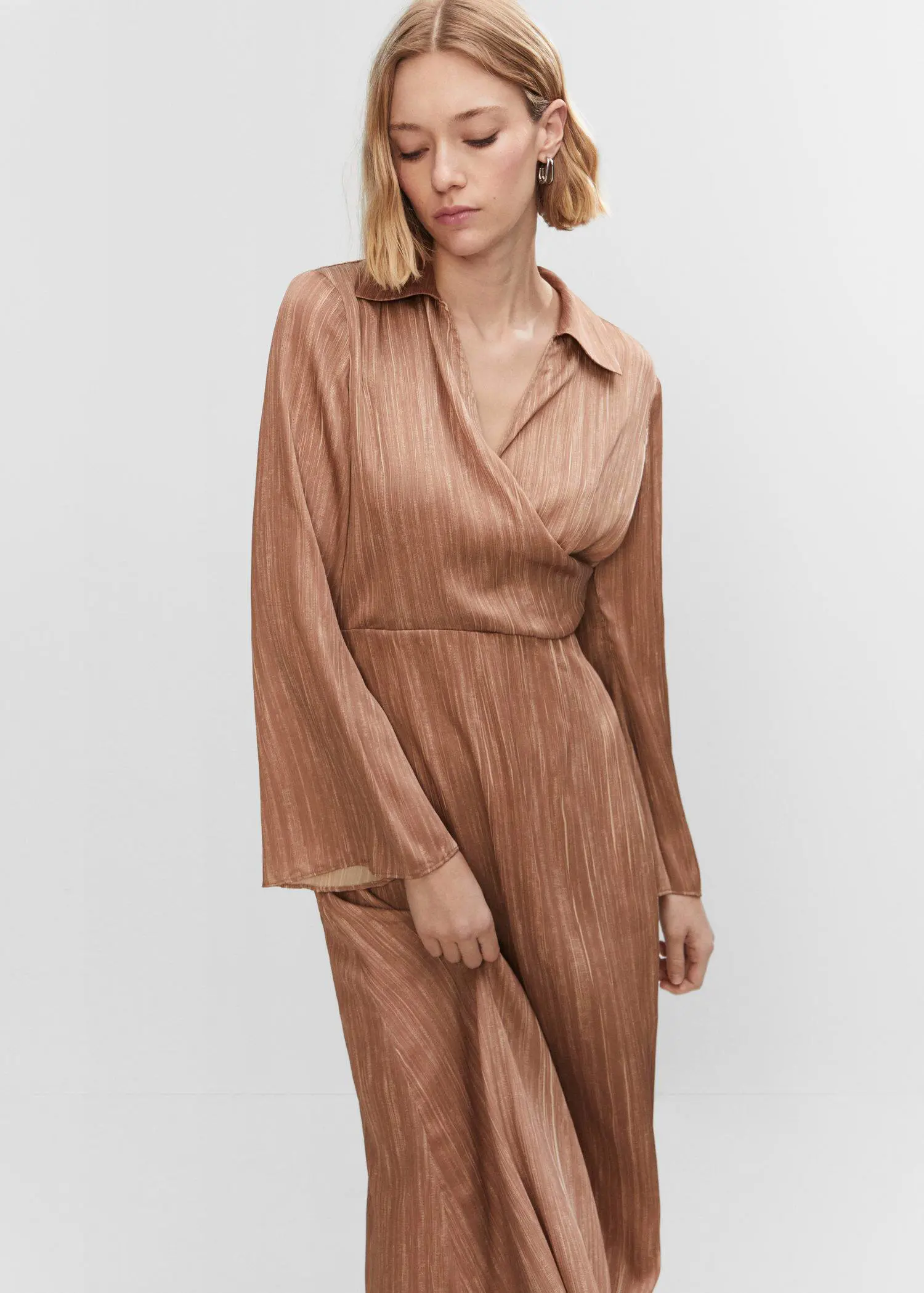 Mango Satin shirt dress. a woman wearing a brown dress standing in front of a wall. 