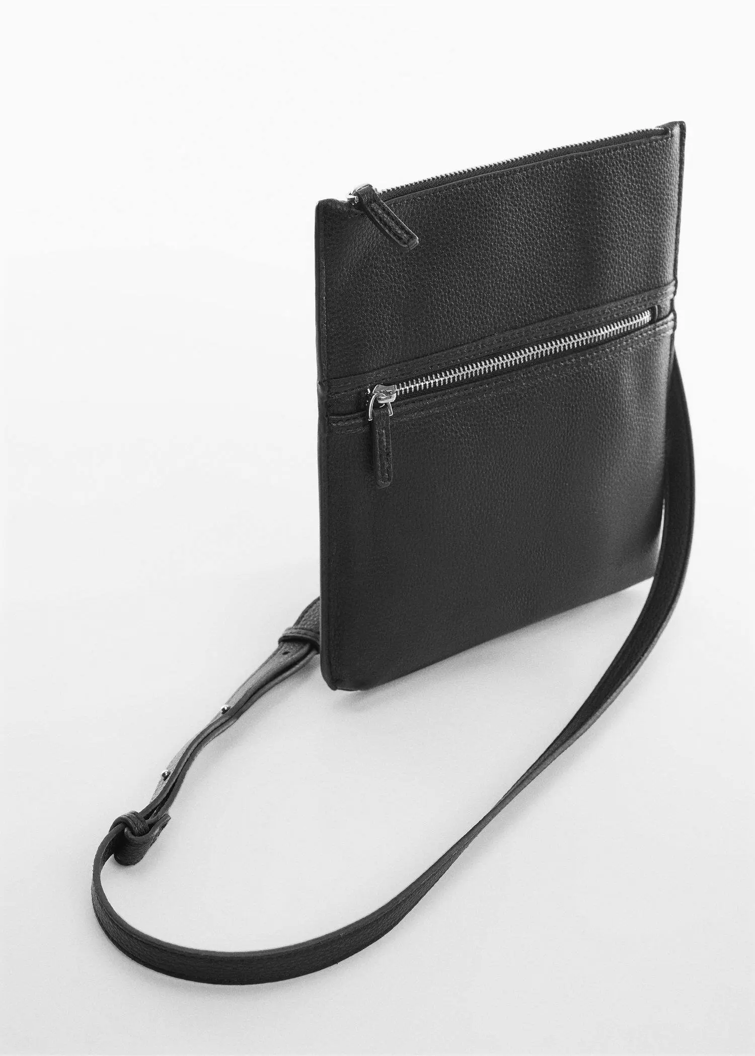 Mango Leather effect zippered shoulder bag. a close up of a black purse on a white surface 