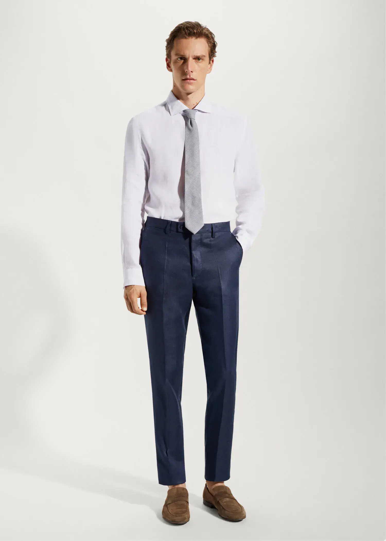 Mango 100% linen suit trousers. a man in a white shirt and blue pants. 