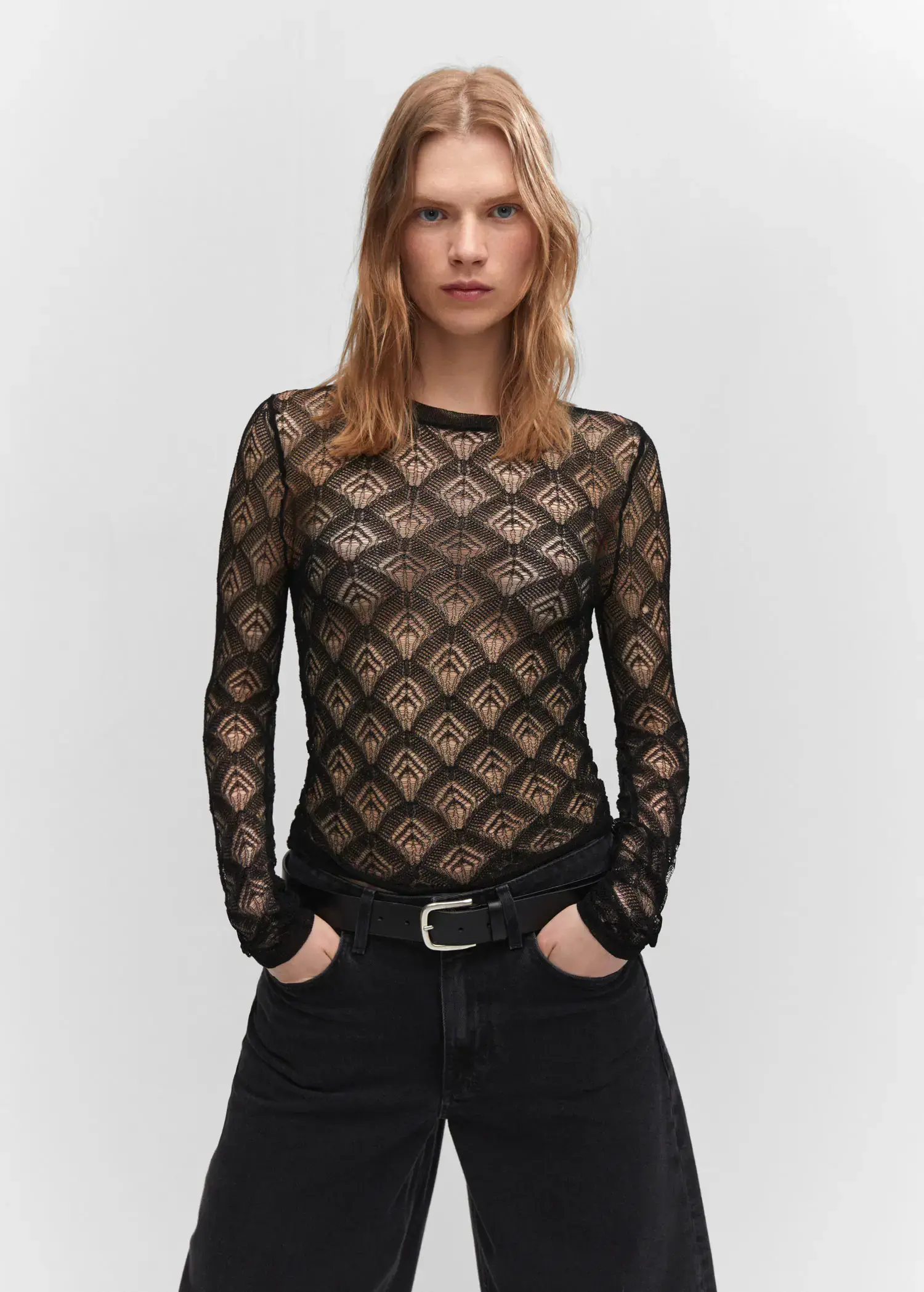 Mango Geometric openwork T-shirt. a woman in a black shirt and black pants. 