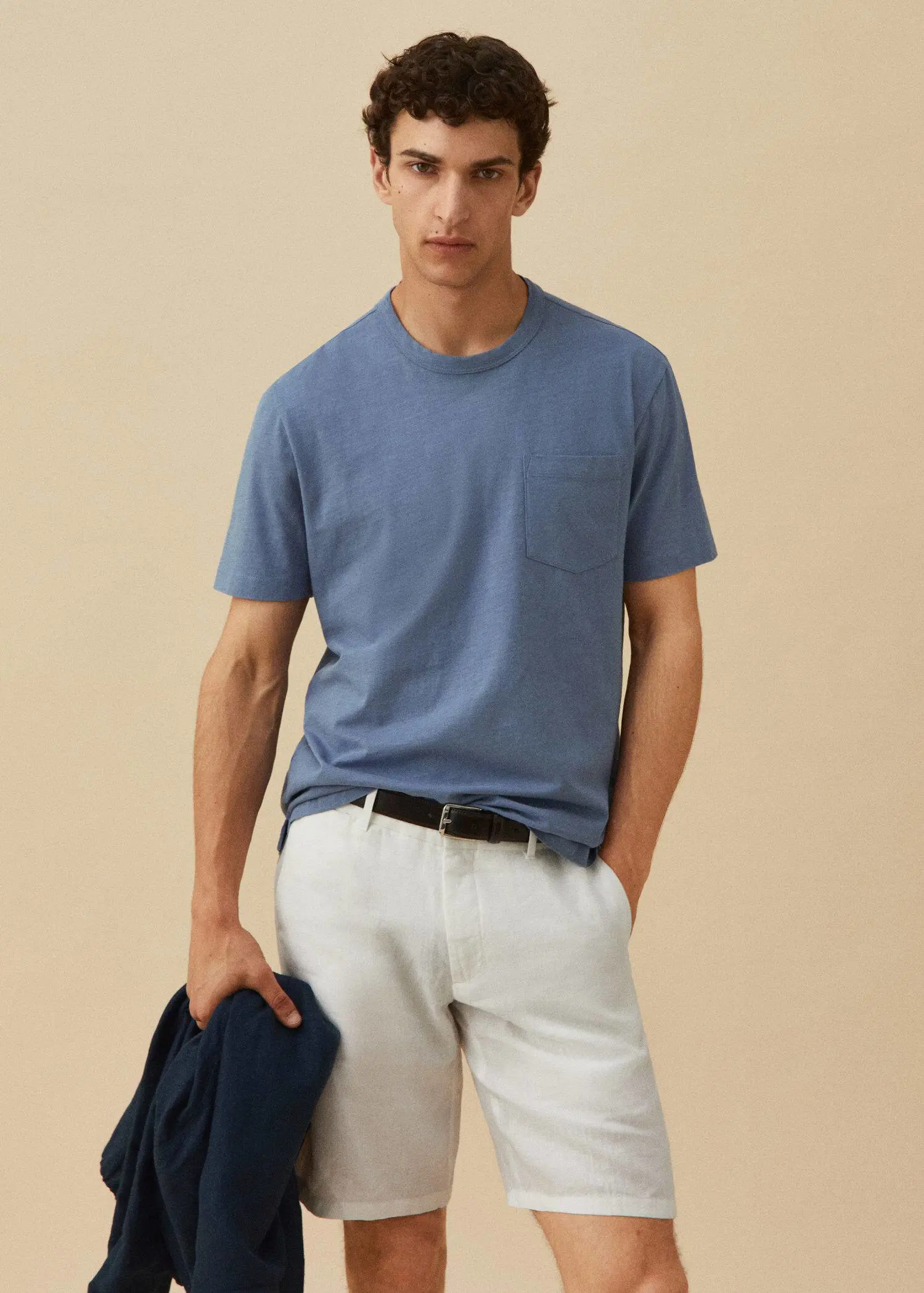 Mango 100% cotton t-shirt with pocket. a man in a blue shirt and white shorts. 