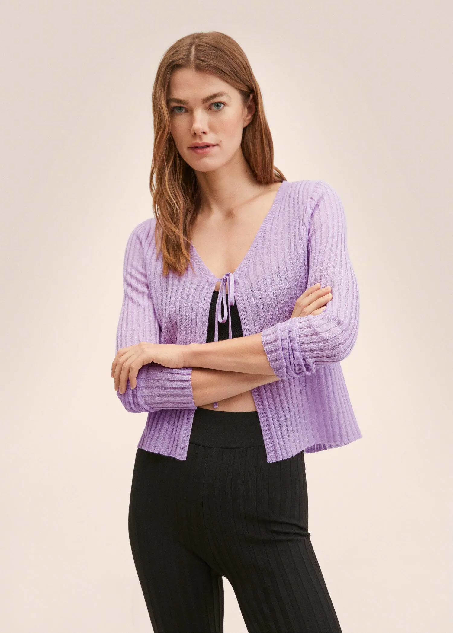 Mango Knitted cropped cardigan. a woman wearing a purple sweater and a black skirt. 