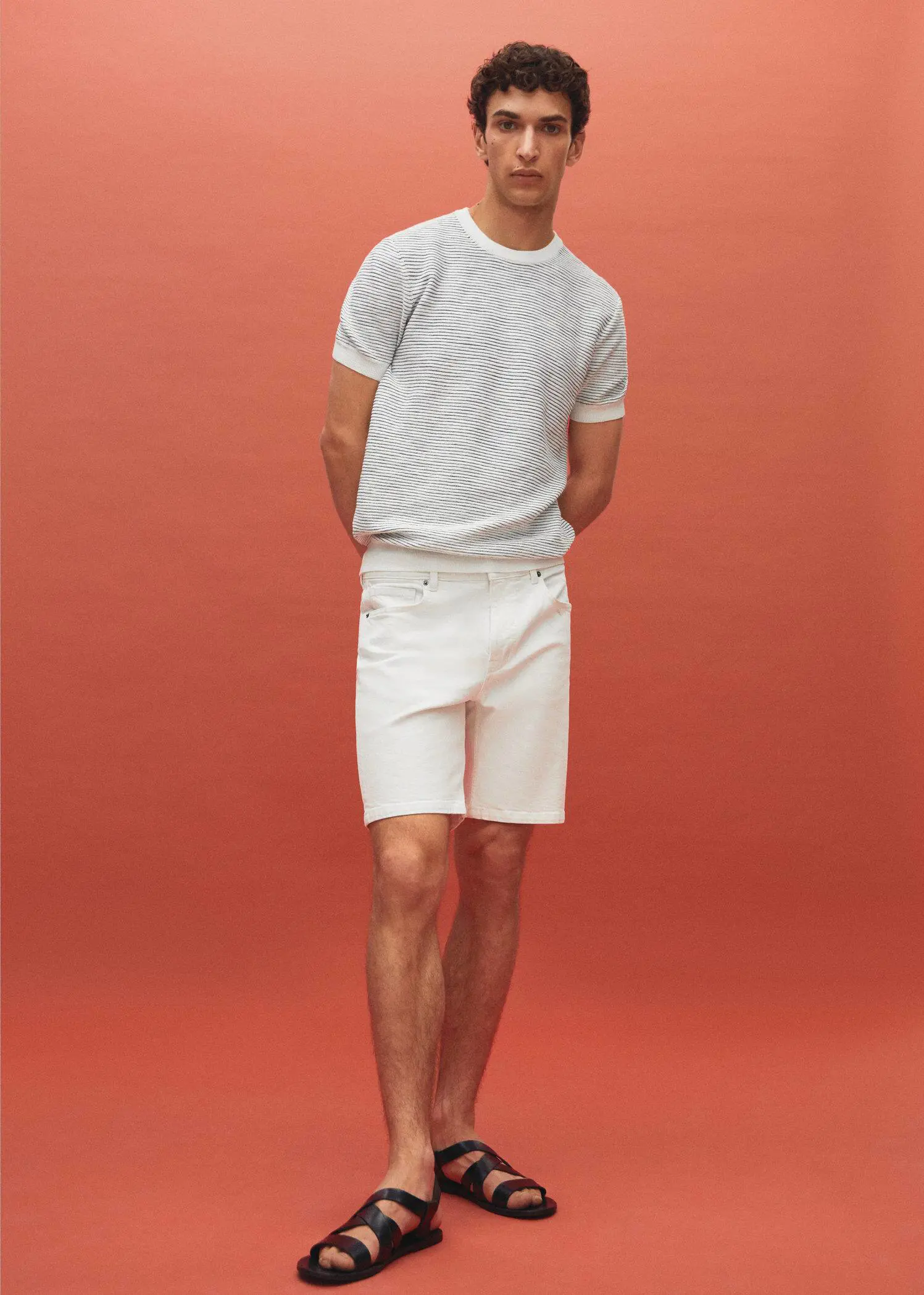 Mango Regular-fit denim bermuda shorts. a man in white shorts and a white t-shirt 