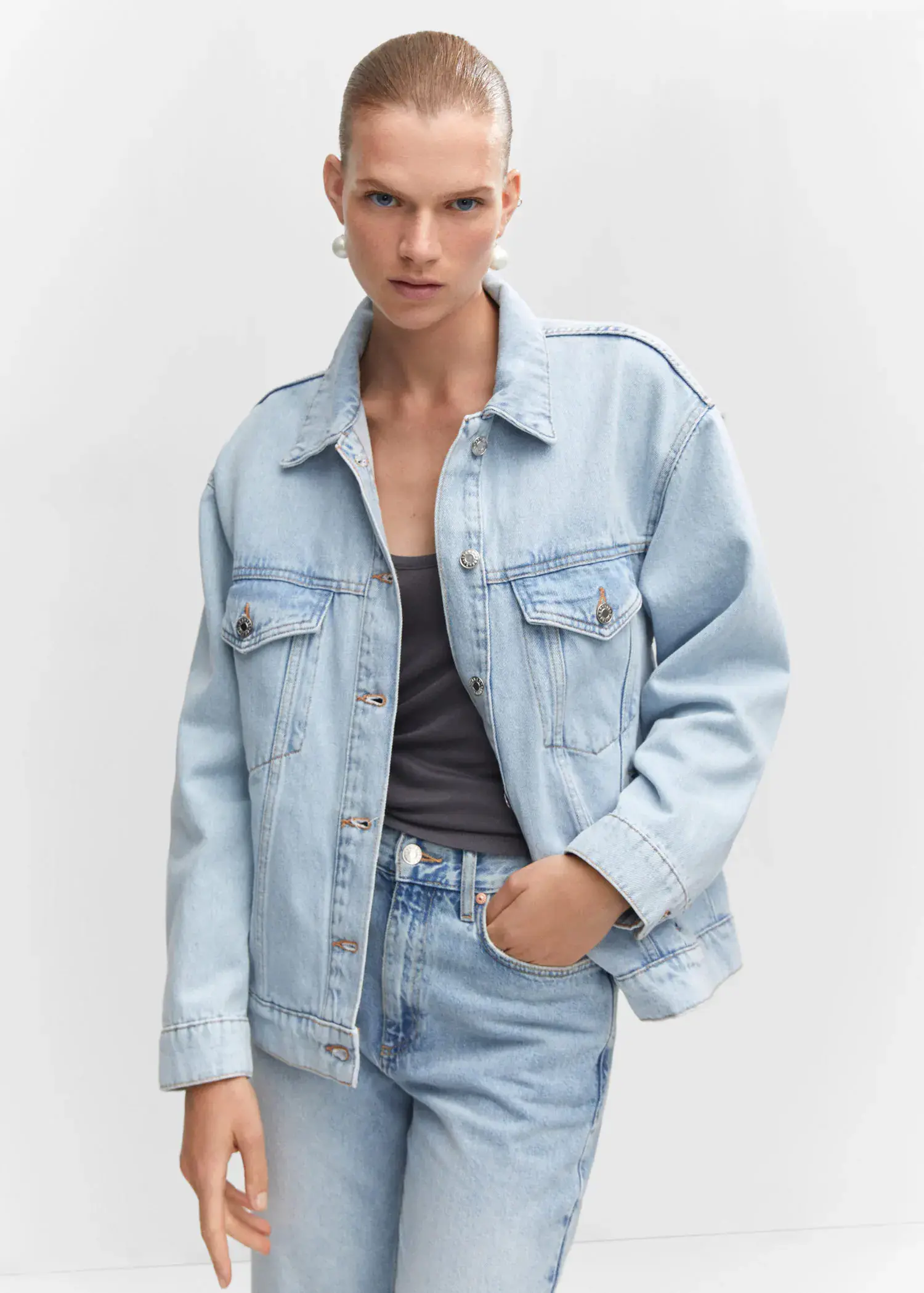 Mango Oversize denim jacket. a woman wearing a denim jacket and jeans. 