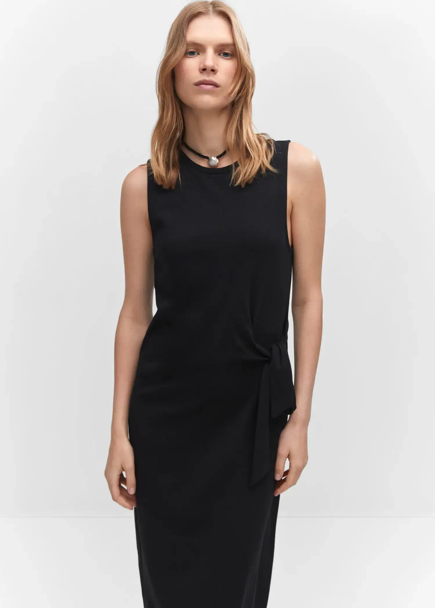 Mango Bow cut-out detail dress. a woman wearing a black dress and a necklace. 