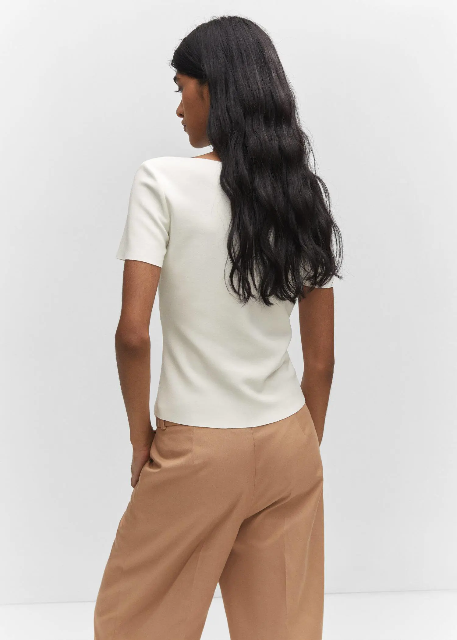 Mango Square neck t-shirt. a woman in a white shirt and brown shorts. 