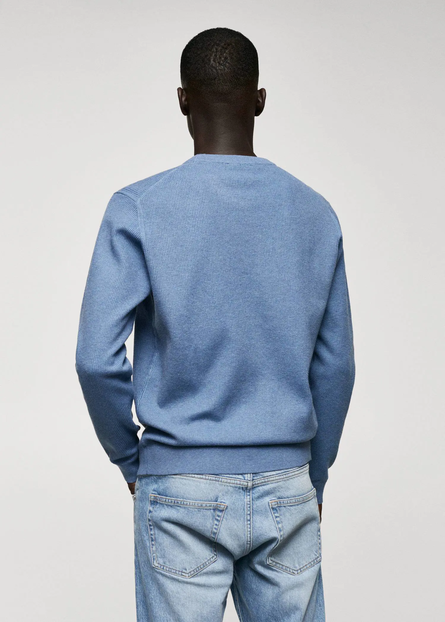 Mango Structured cotton sweater. a person wearing a blue sweatshirt and jeans. 