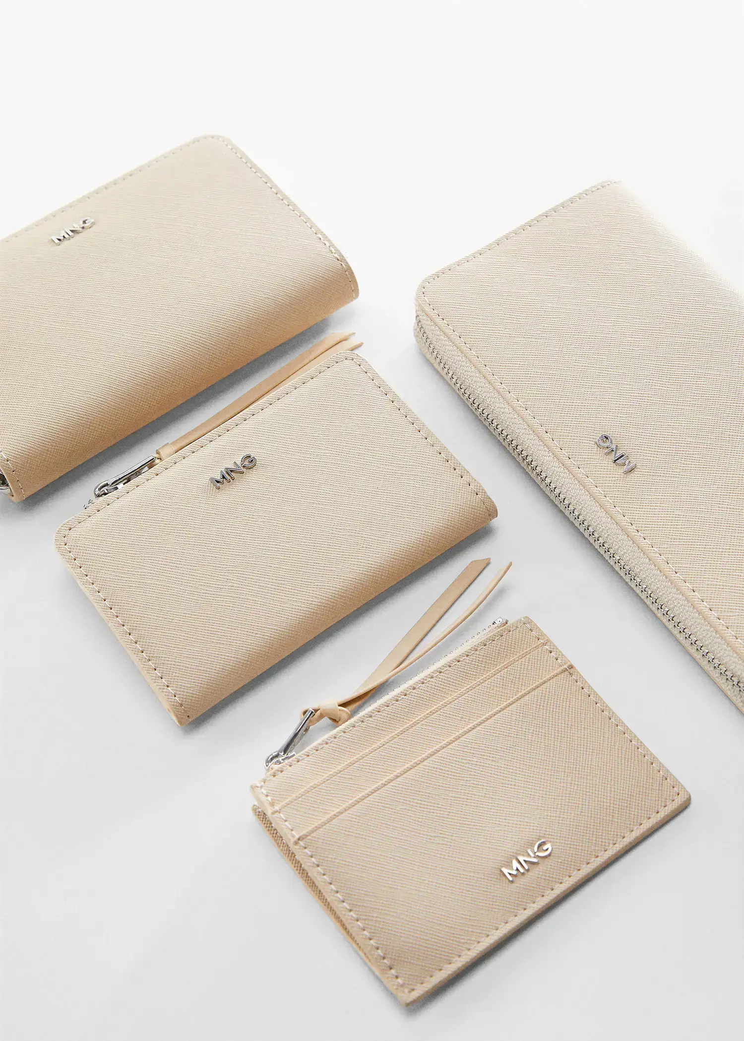 Mango Saffiano-effect cardholder. a set of four beige wallets and purses. 