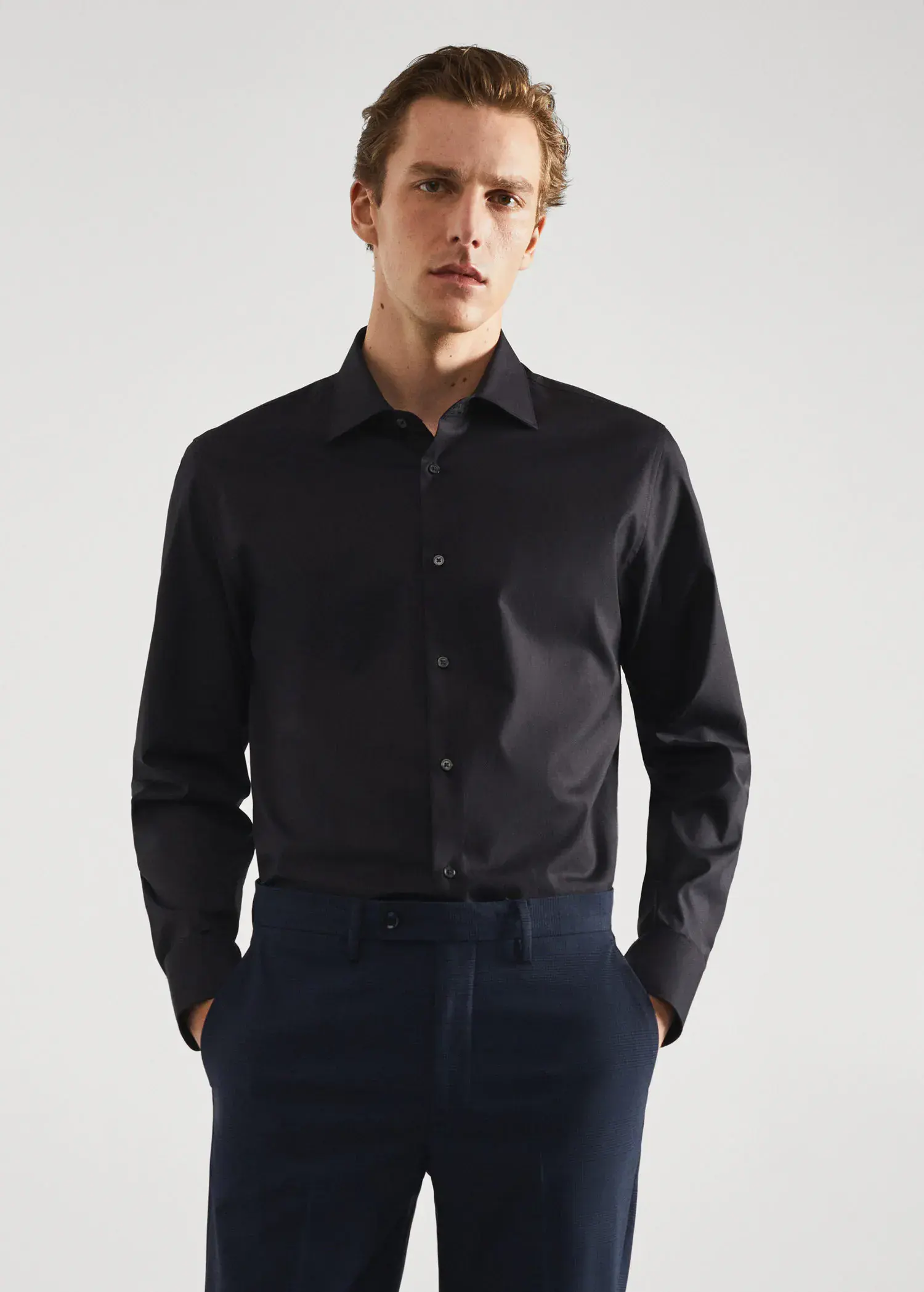 Mango Slim-fit cotton poplin suit shirt. a man wearing a black shirt and blue pants. 