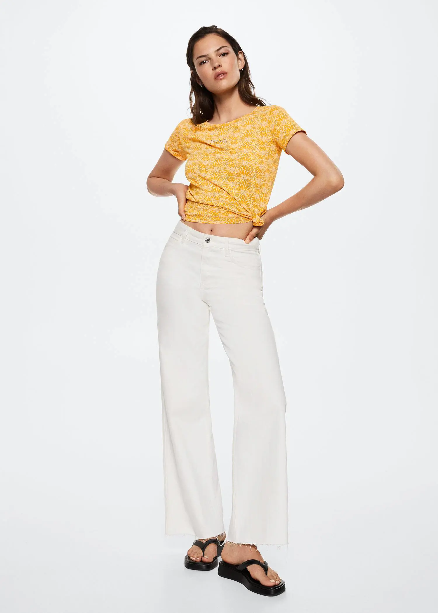 Mango Printed cotton-blend T-shirt. a woman wearing white pants and a yellow top. 
