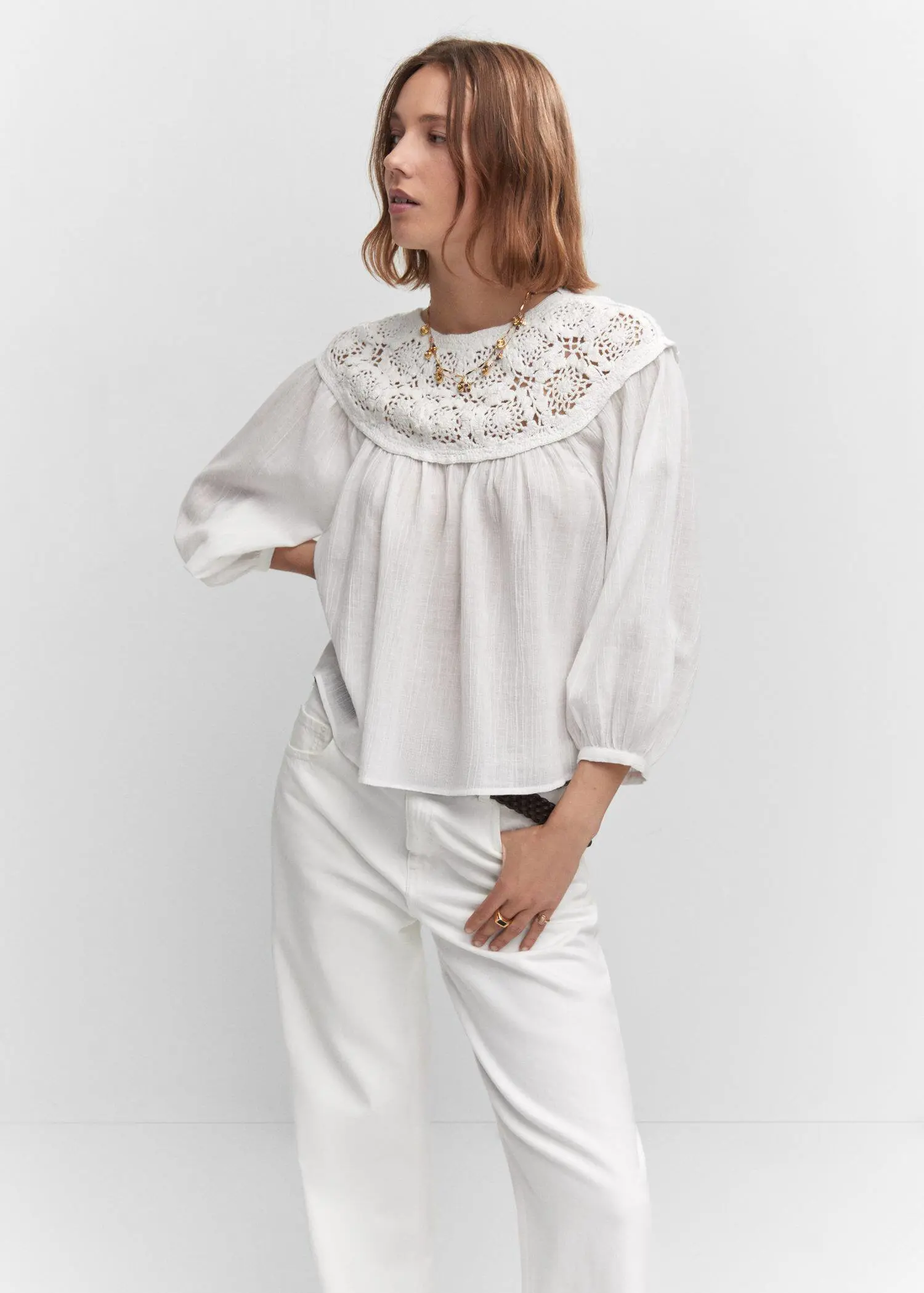 Mango Crochet panel blouse. a woman wearing a white blouse and white pants. 