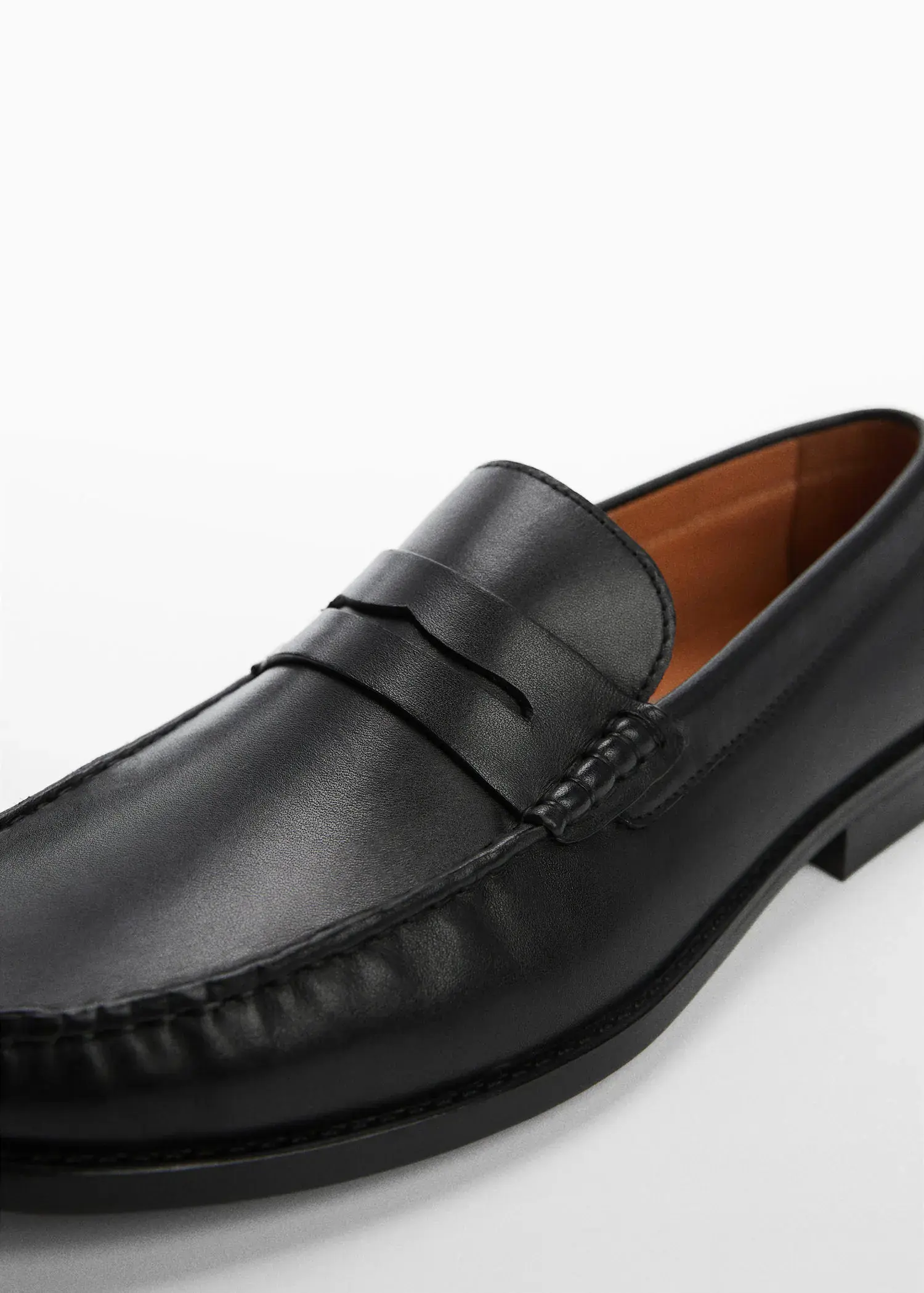 Mango Leather penny loafers. a close-up of a black loafer shoe. 